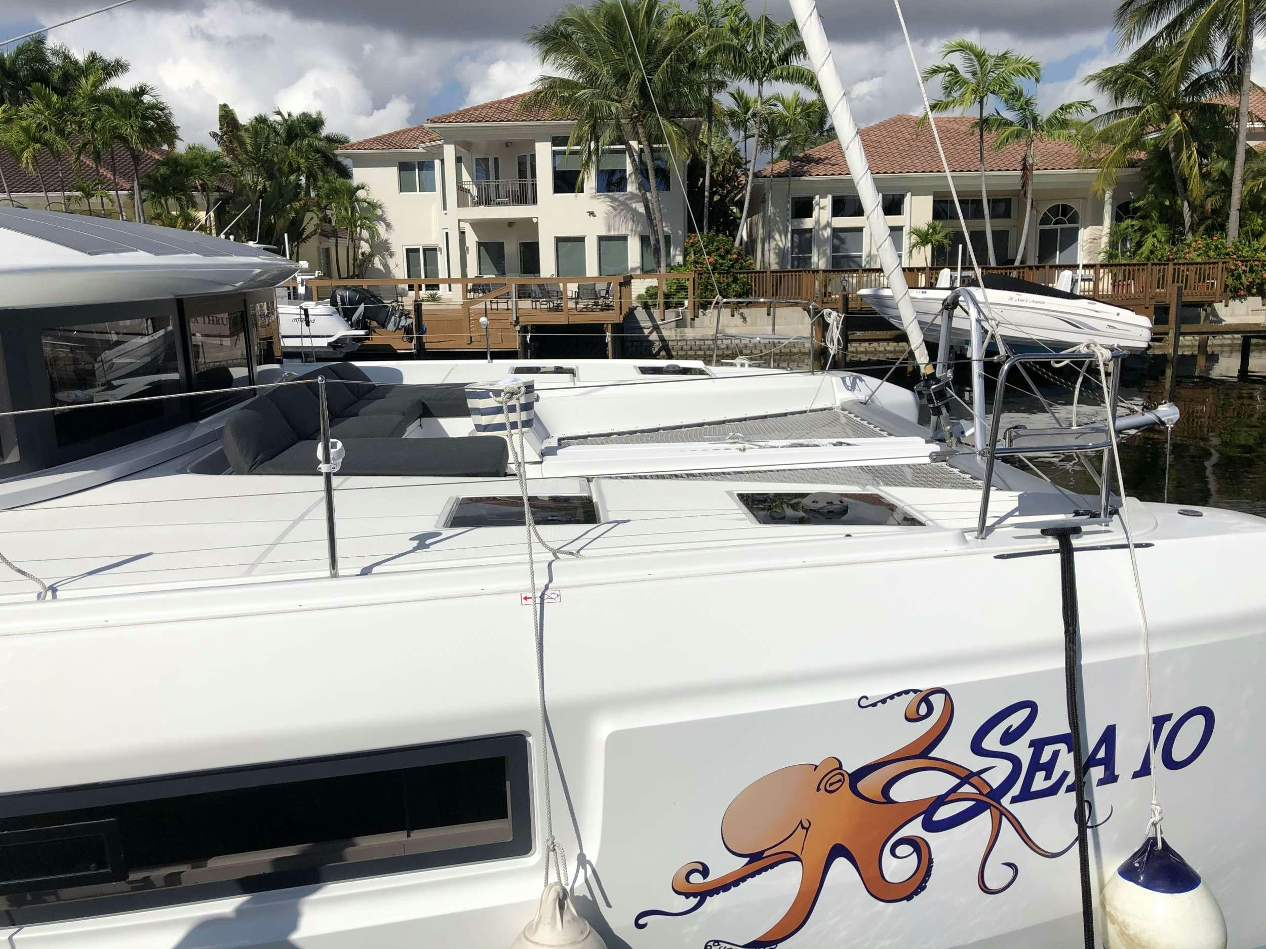 a white boat with a sign on the front aboard SEA IO Yacht for Charter