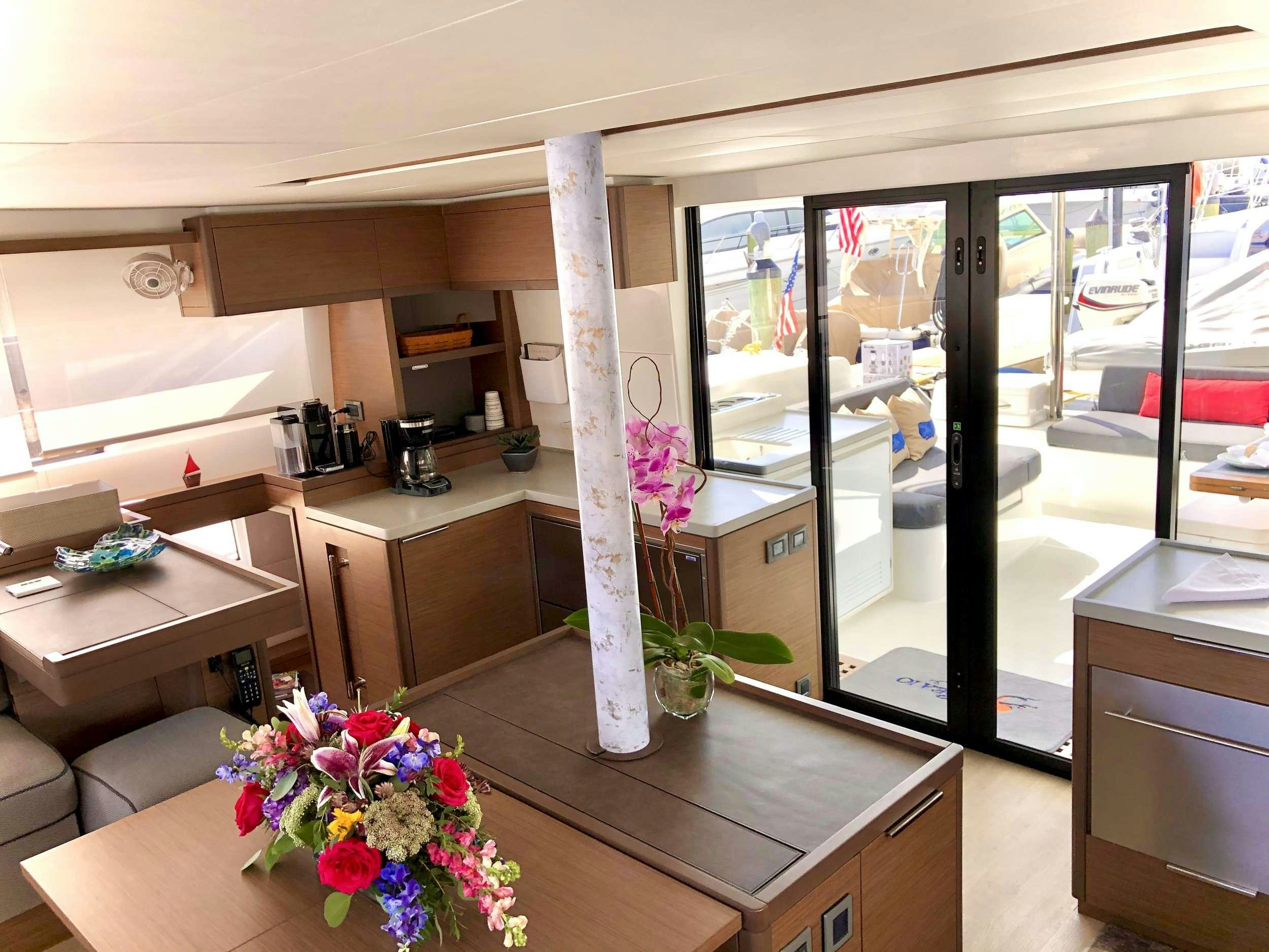 a room with a table and chairs aboard SEA IO Yacht for Charter