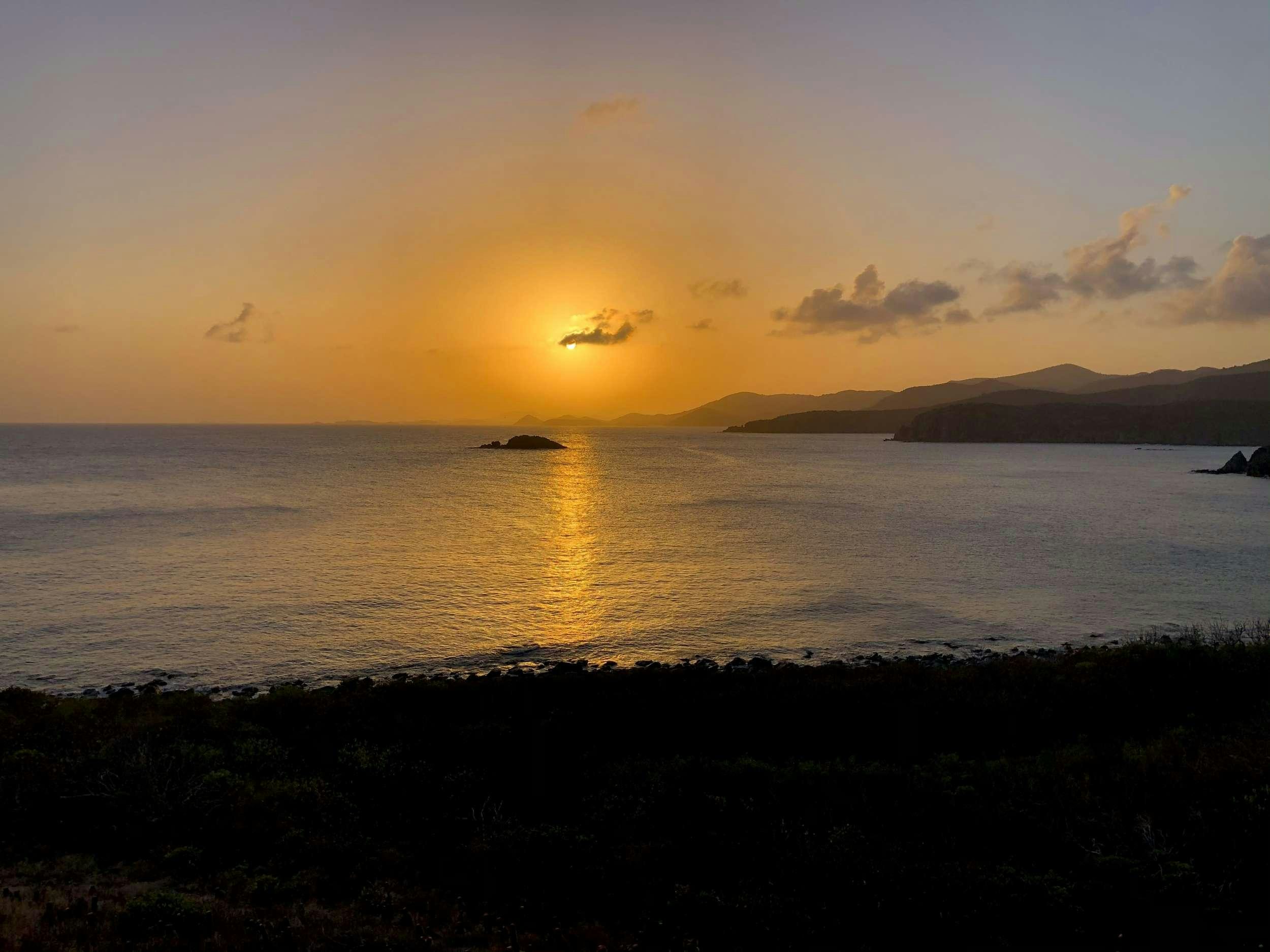 a body of water with land in the background aboard SEA IO Yacht for Charter