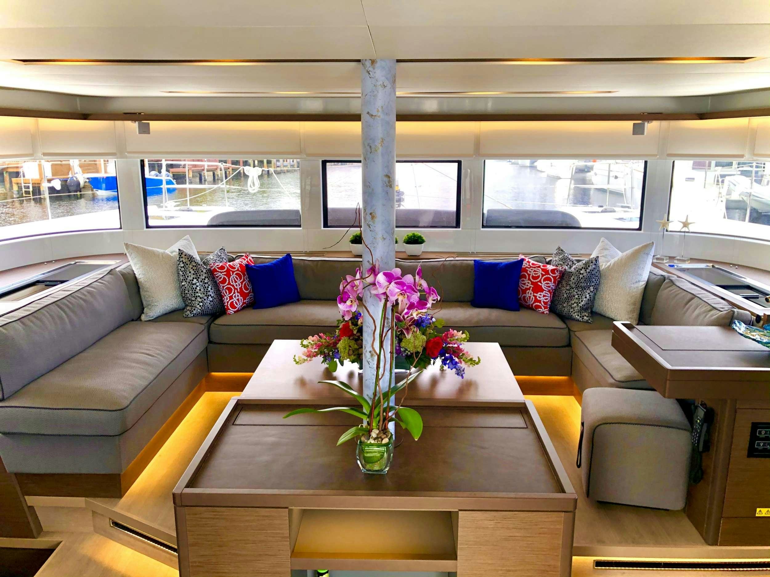 a living room with a vase of flowers on a table aboard SEA IO Yacht for Charter