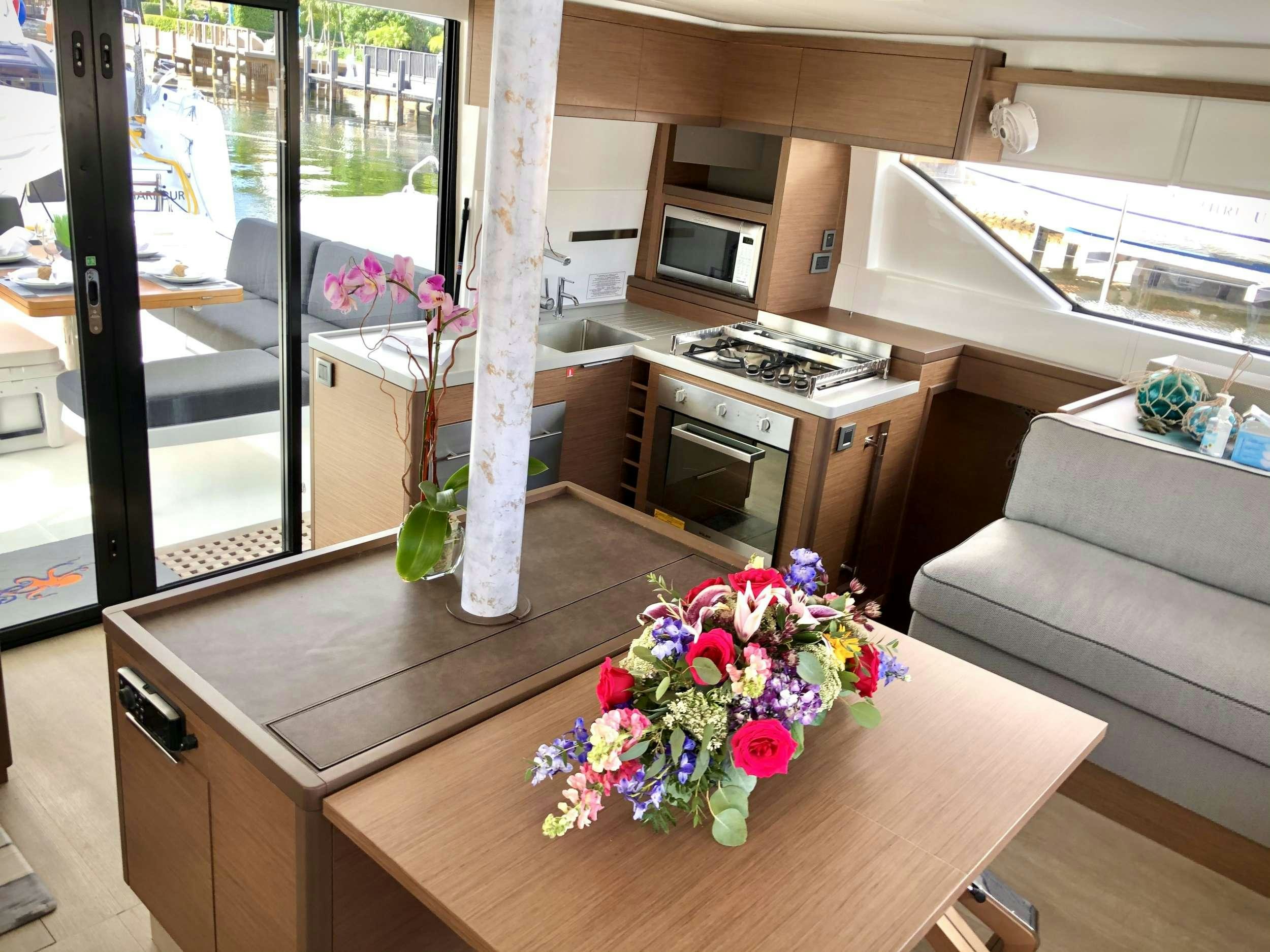 a living room with a table and a couch aboard SEA IO Yacht for Charter