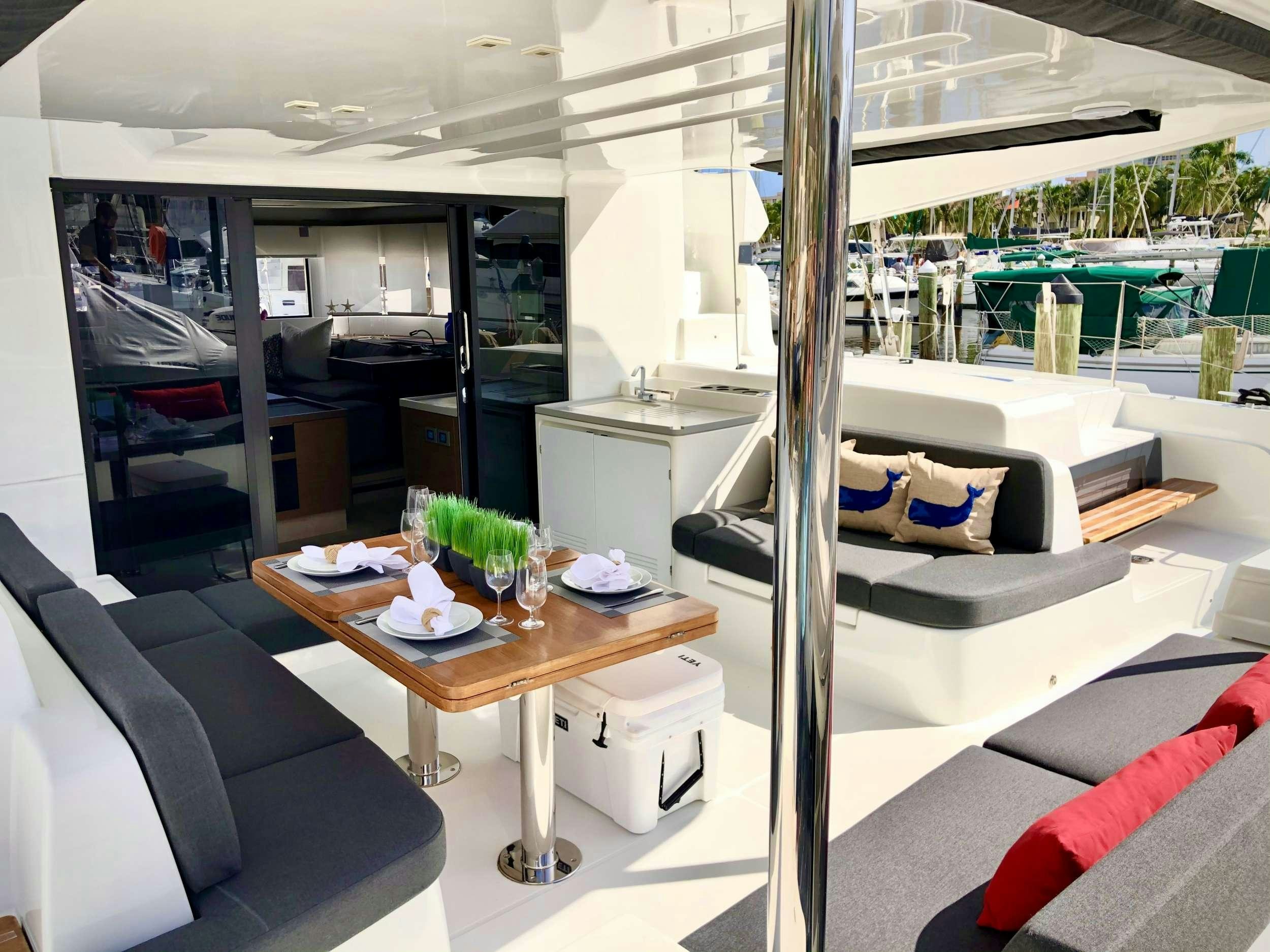 a room with a bed and a table aboard SEA IO Yacht for Charter