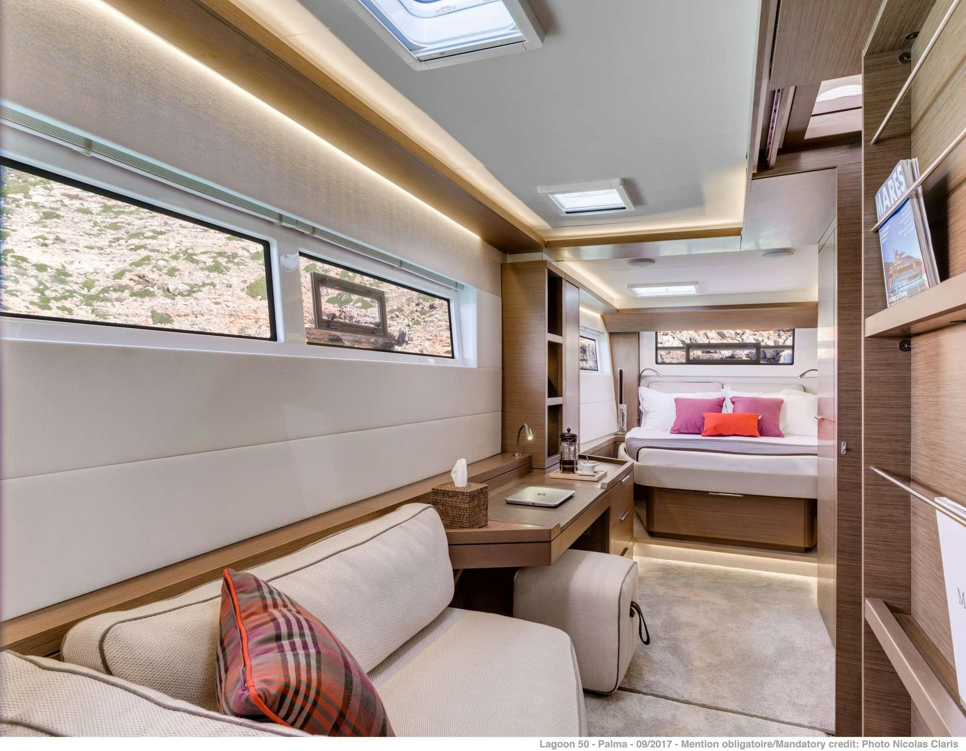 a room with a couch and a table aboard SEA IO Yacht for Charter