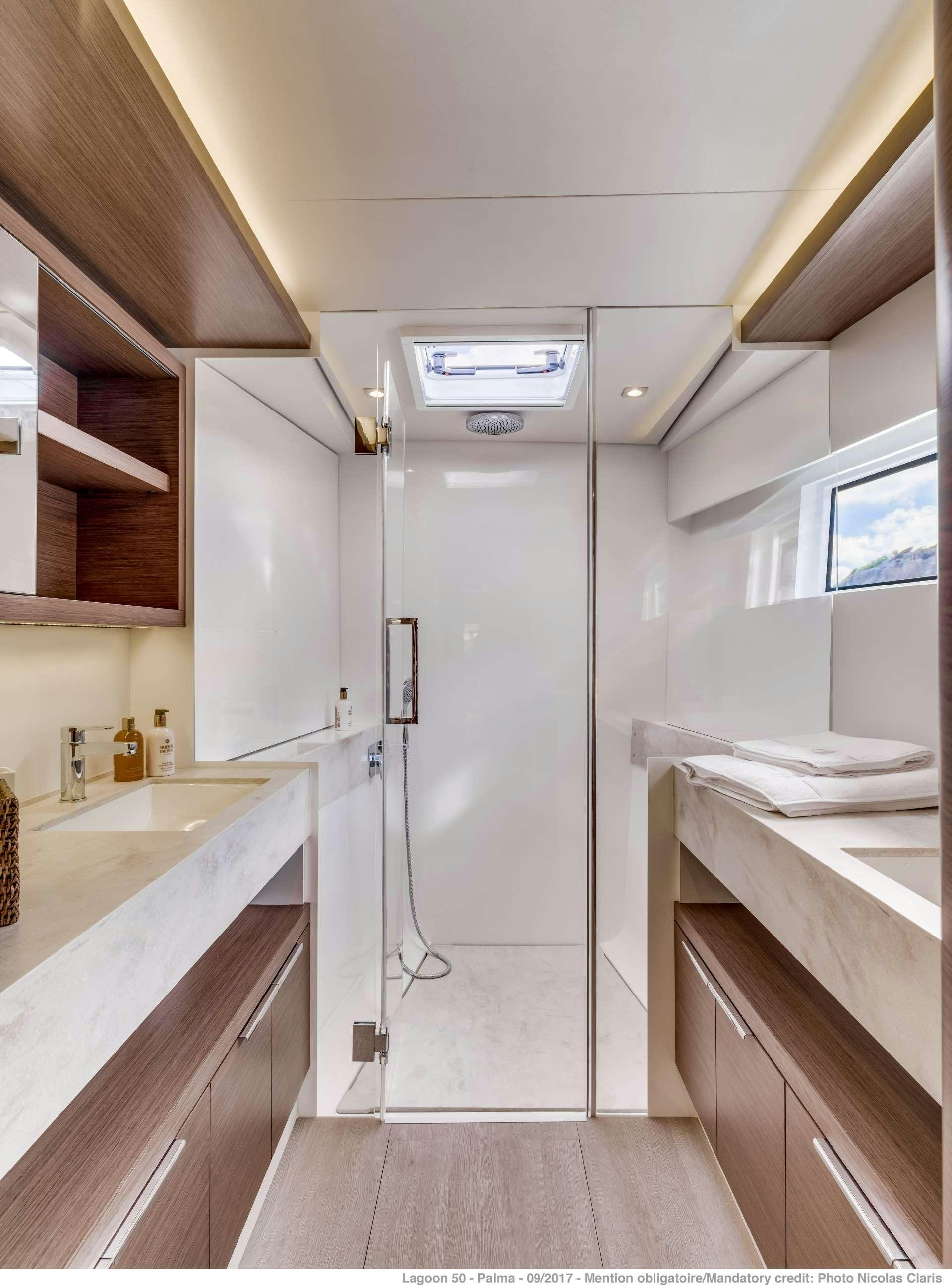 a bathroom with a shower unit and sink aboard SEA IO Yacht for Charter