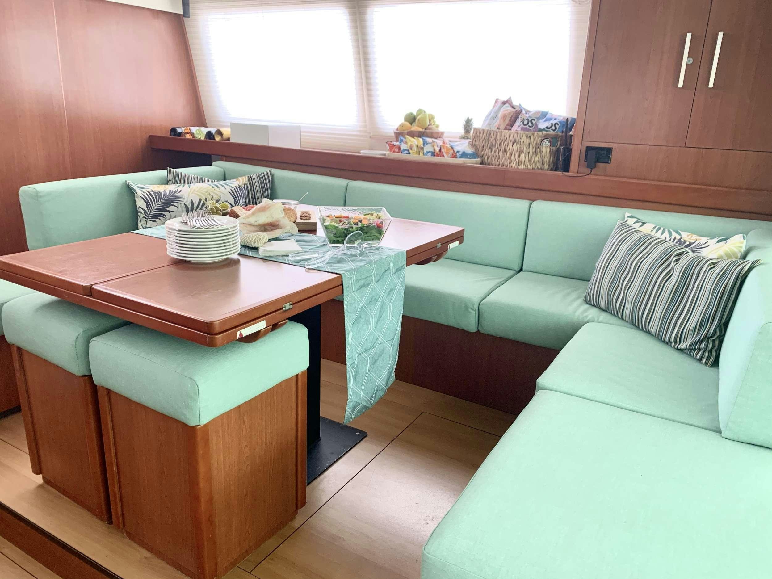 a kitchen with a table and chairs aboard DOLPHIN DAZE Yacht for Charter