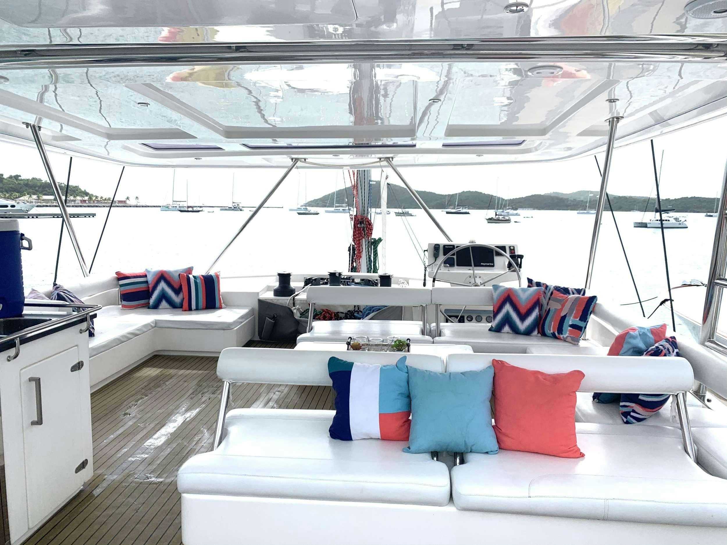 a boat with pillows on a deck aboard DOLPHIN DAZE Yacht for Charter