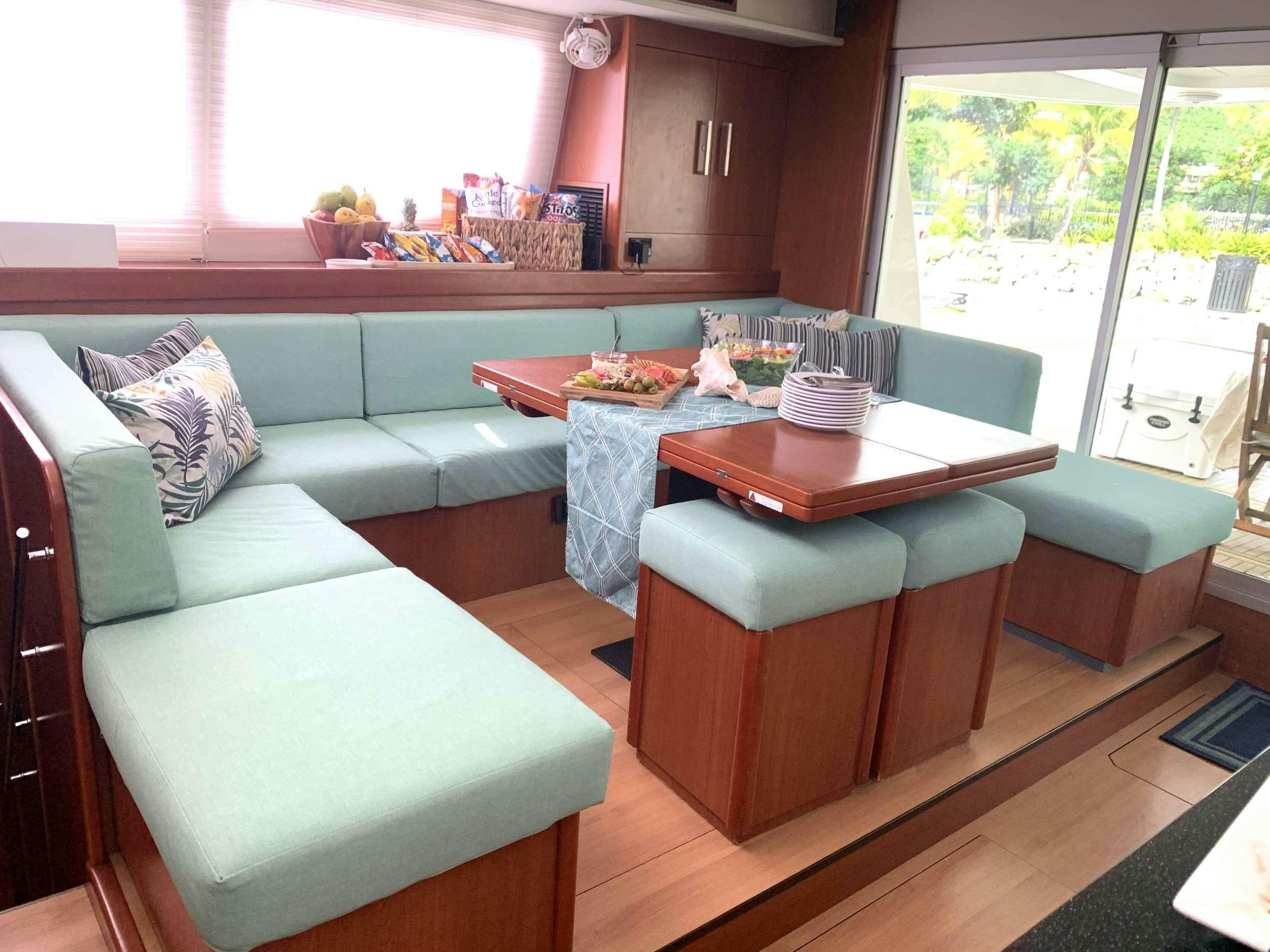 a living room with a couch and a table aboard DOLPHIN DAZE Yacht for Charter