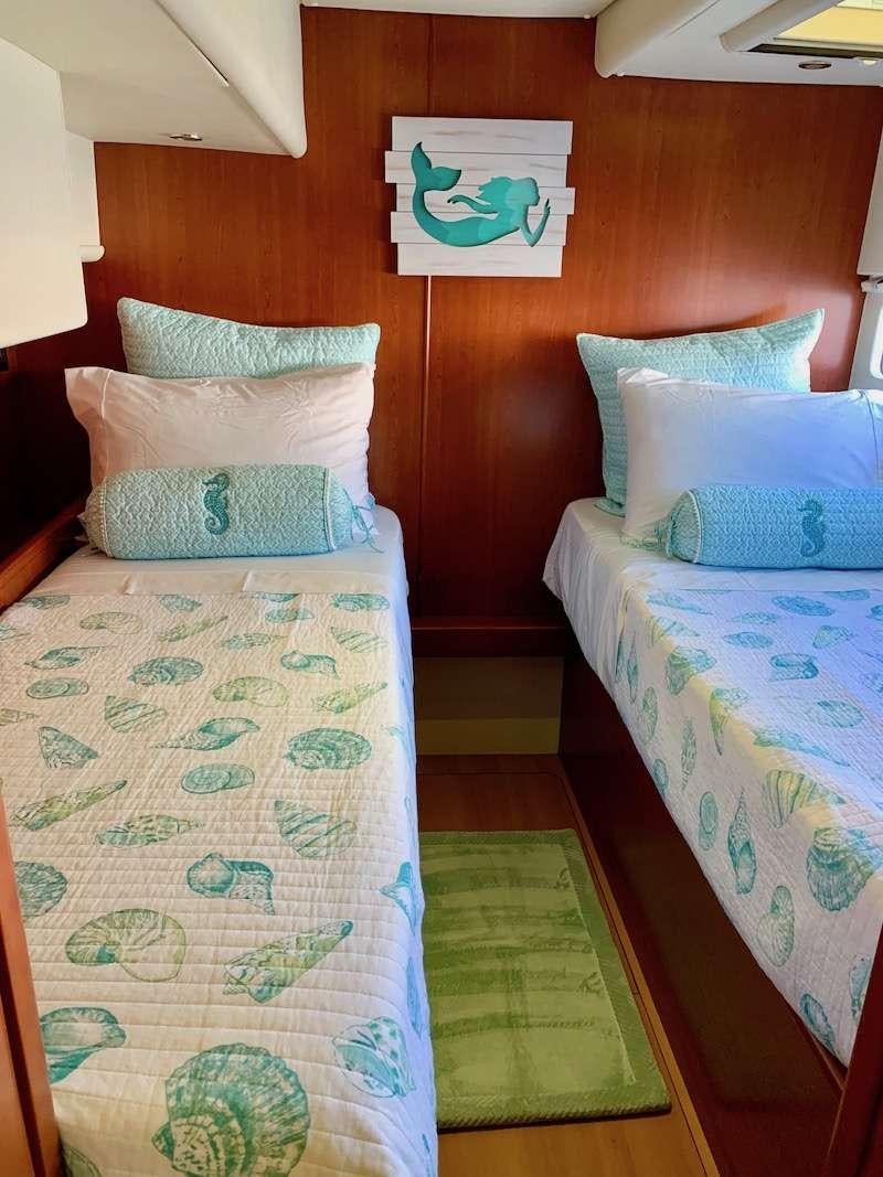 a couple of beds in a room aboard DOLPHIN DAZE Yacht for Charter