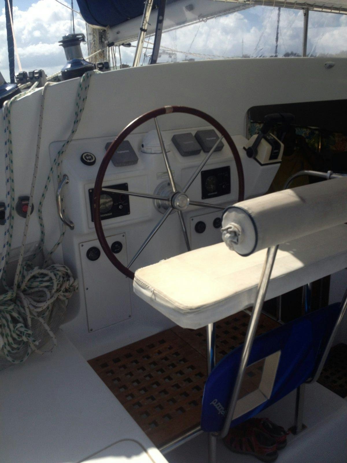a white boat with a steering wheel aboard MANGO Yacht for Charter