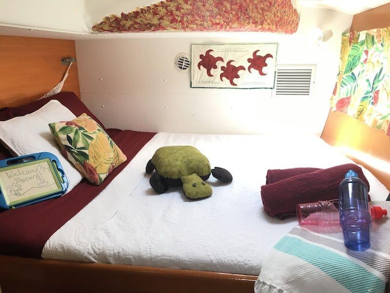 a stuffed animal on a bed aboard MANGO Yacht for Charter