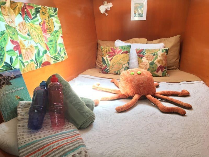 a stuffed toy on a bed aboard MANGO Yacht for Charter