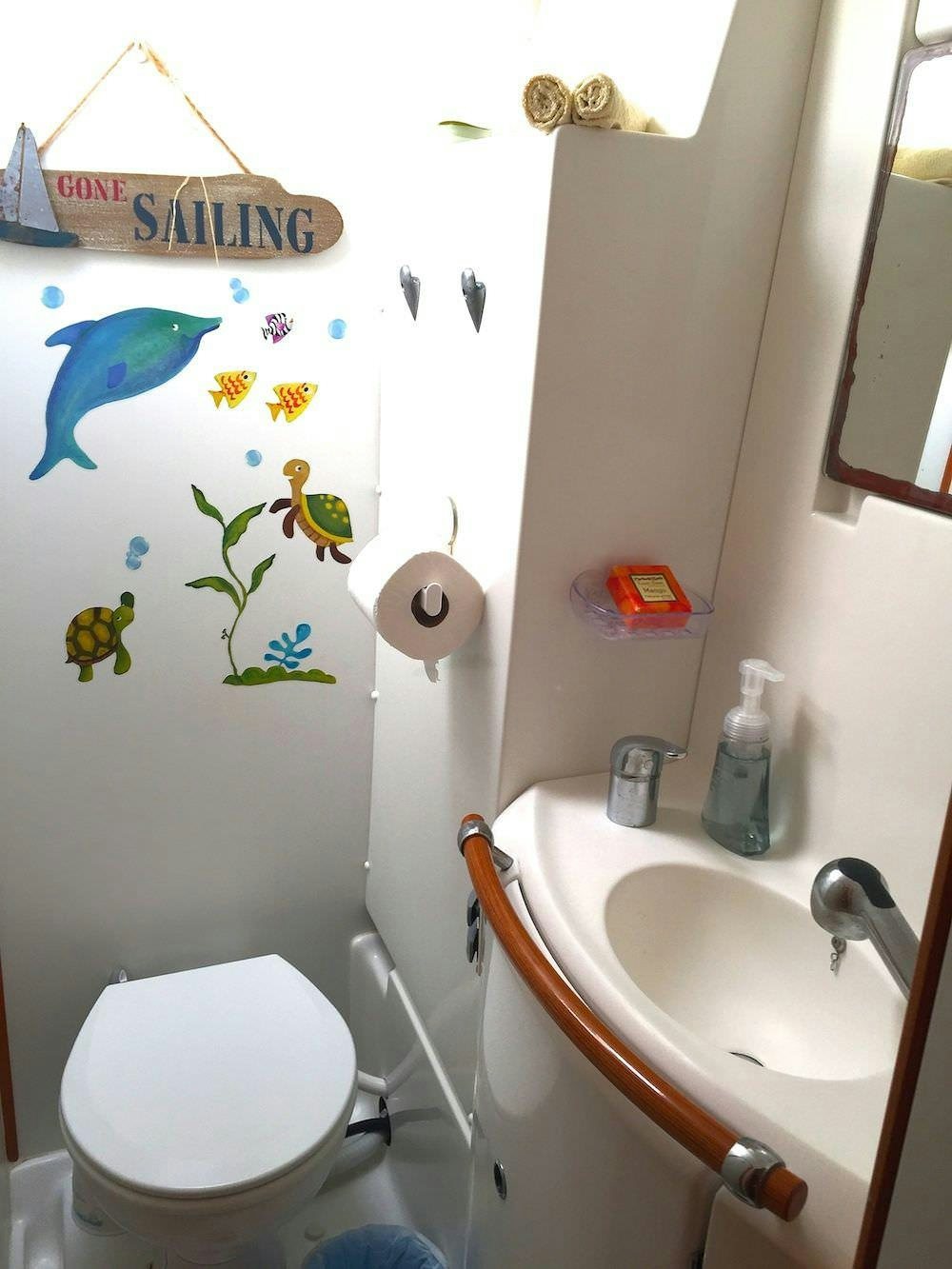 a bathroom with a toilet and sink aboard MANGO Yacht for Charter