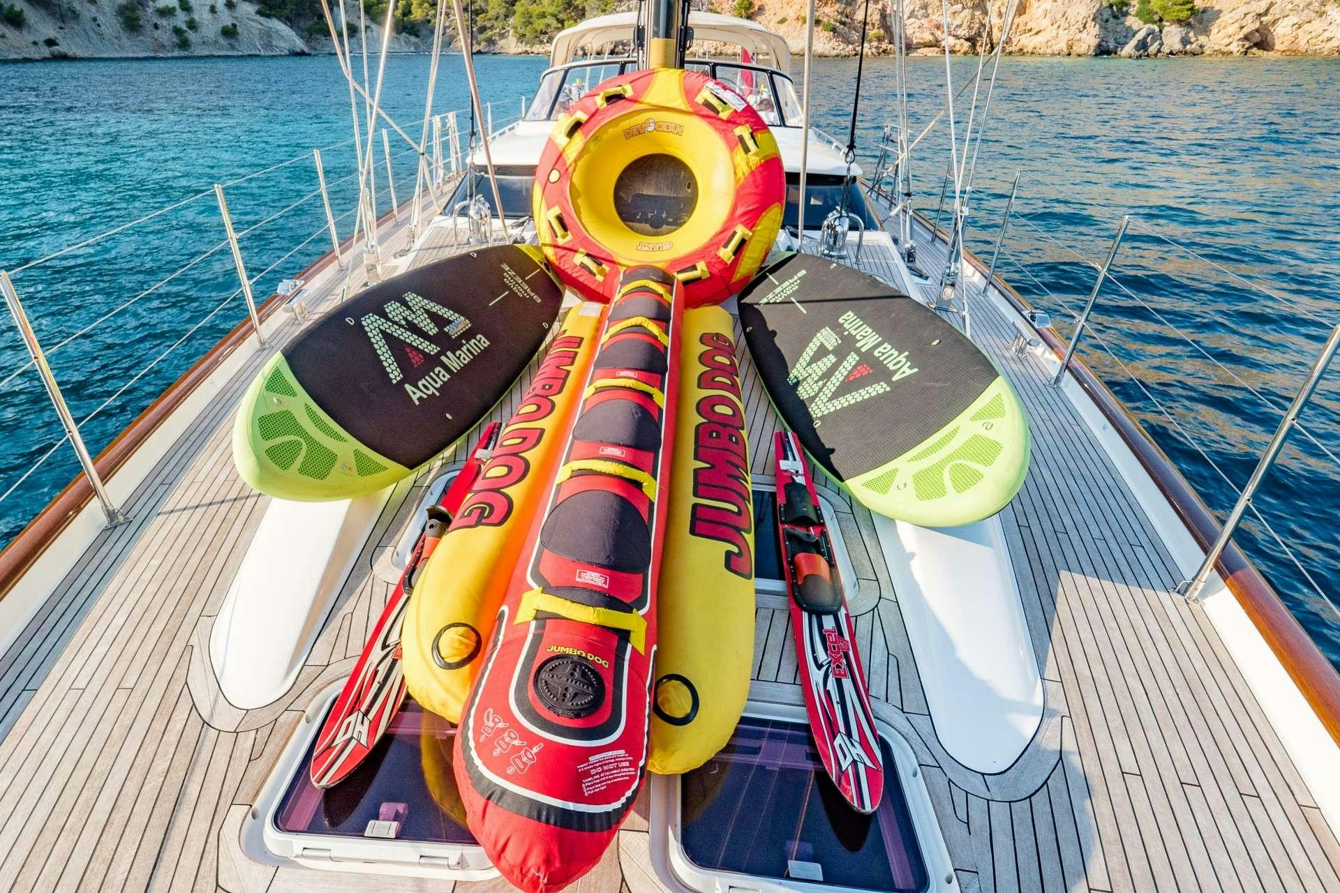a boat with a steering wheel aboard BARE NECESSITIES Yacht for Charter