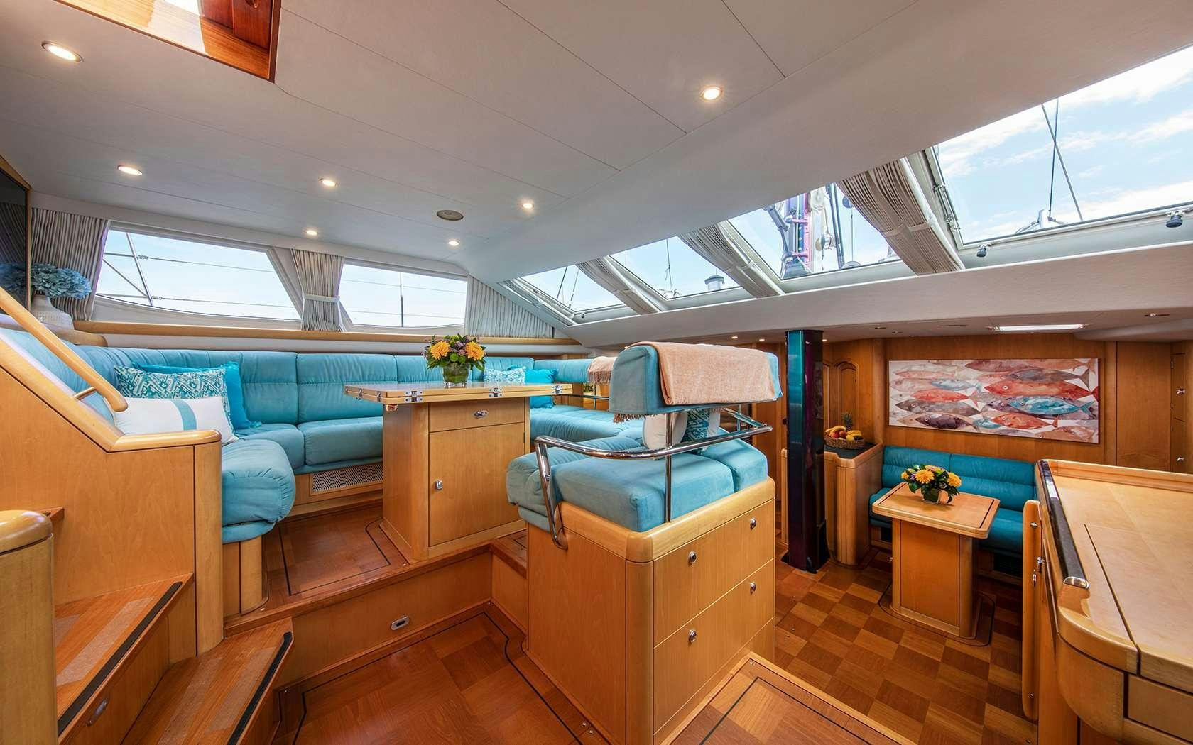 a room with a couch and a table aboard BARE NECESSITIES Yacht for Charter