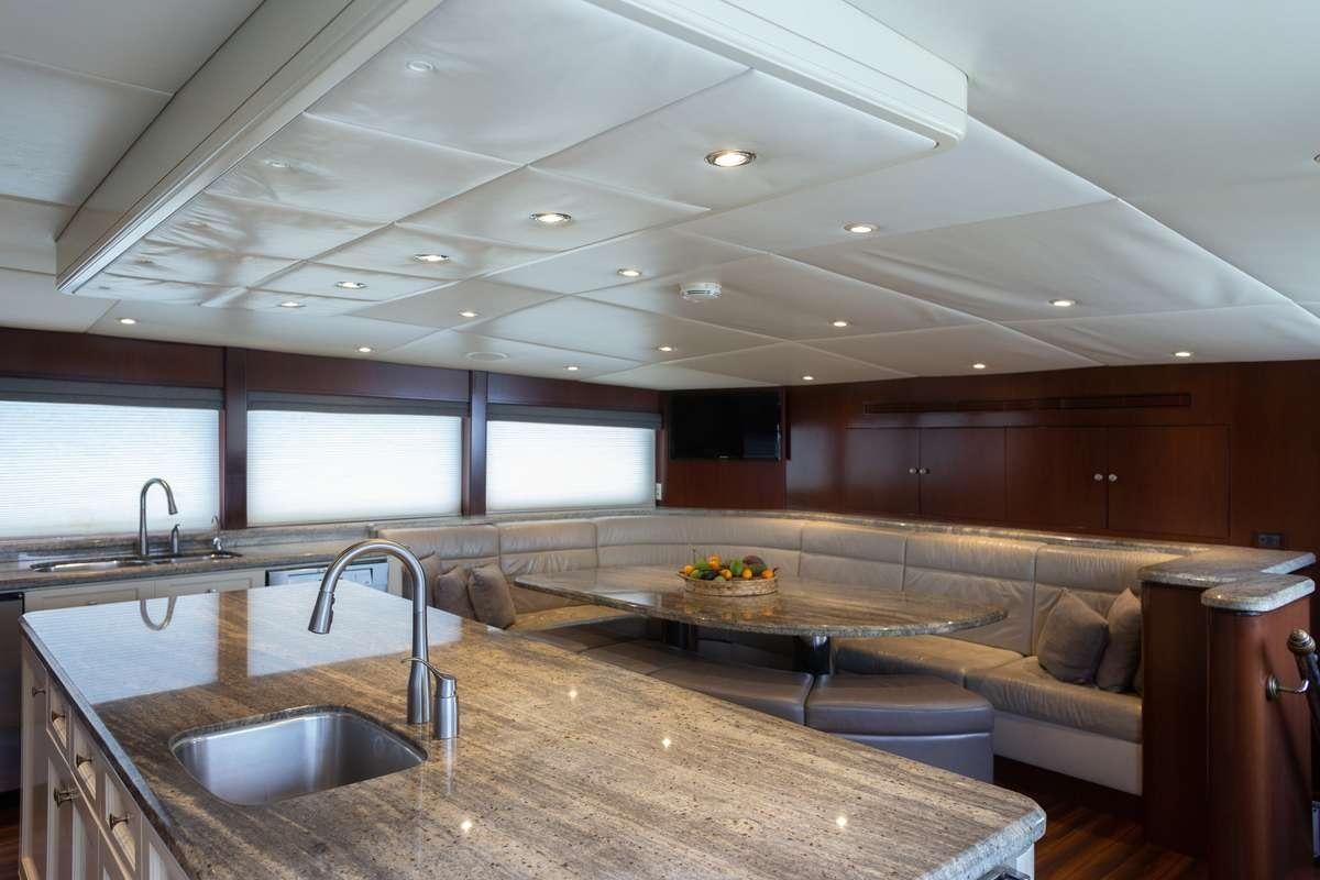 a kitchen with a large island aboard ODIN Yacht for Charter