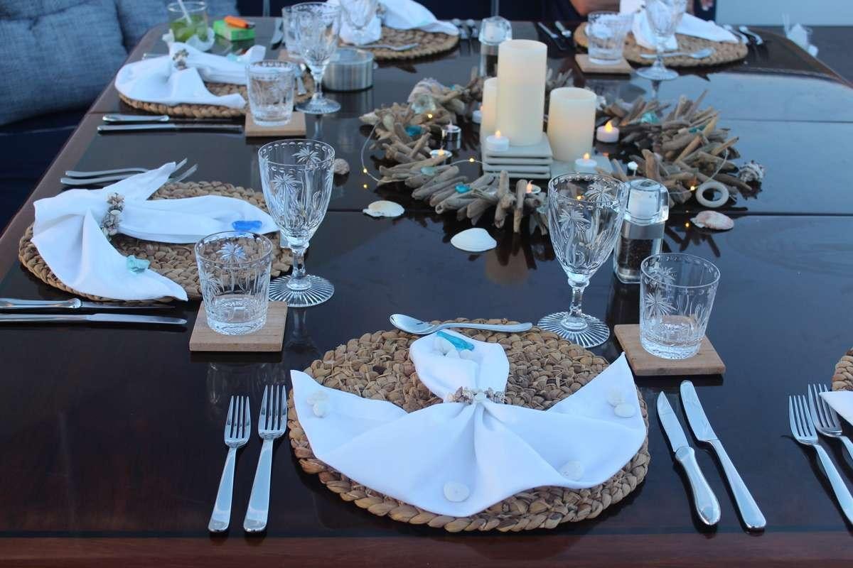 a table with plates and silverware aboard ODIN Yacht for Charter