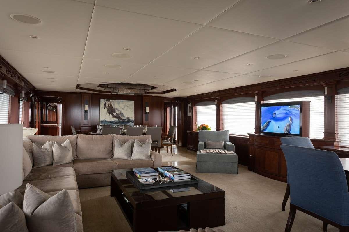 a living room with a large television aboard ODIN Yacht for Charter