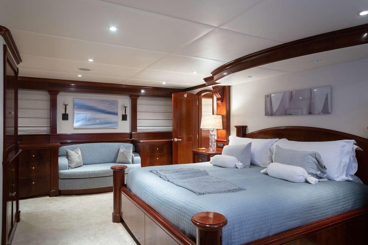 a bedroom with a bed and a couch aboard ODIN Yacht for Charter