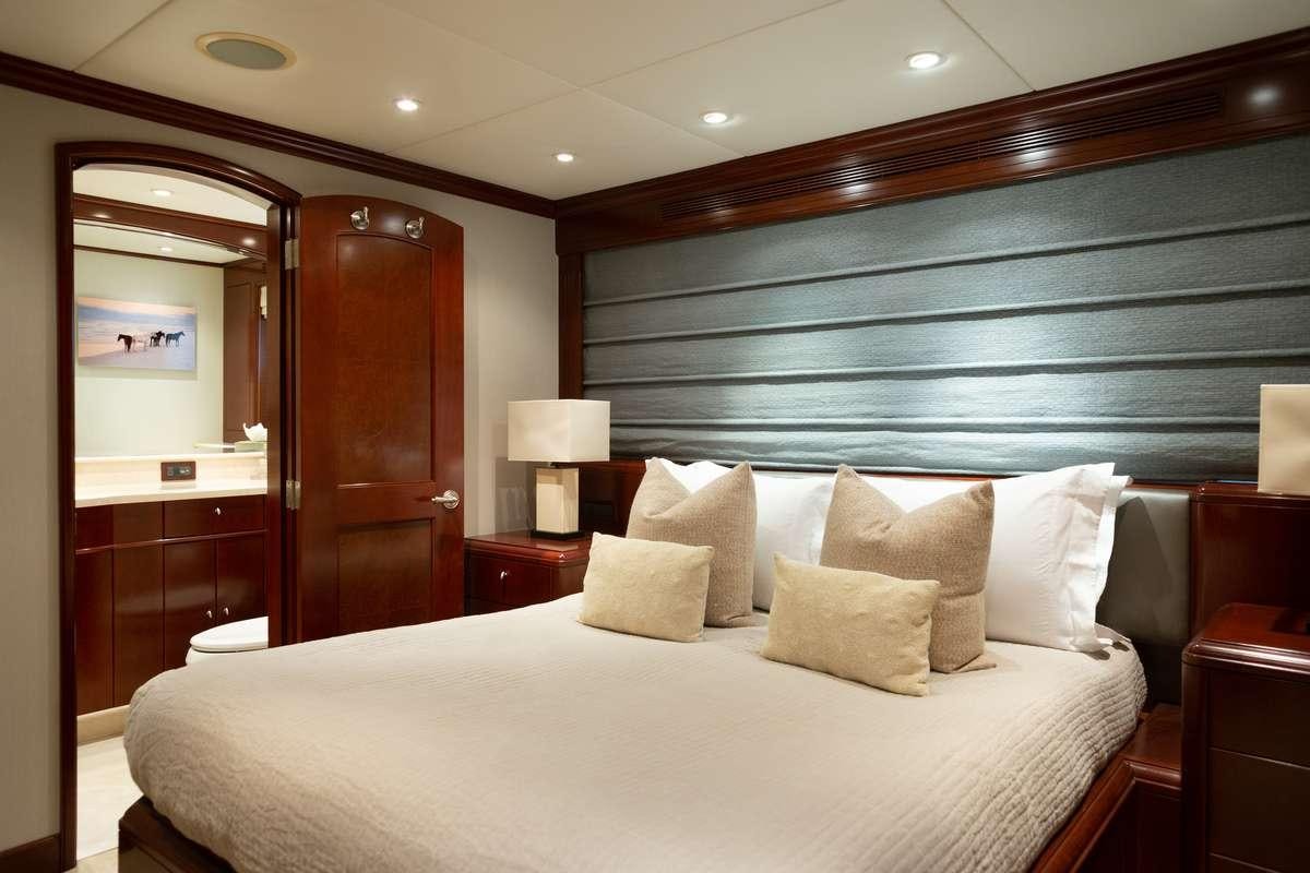 a bed with pillows and a mirror aboard ODIN Yacht for Charter