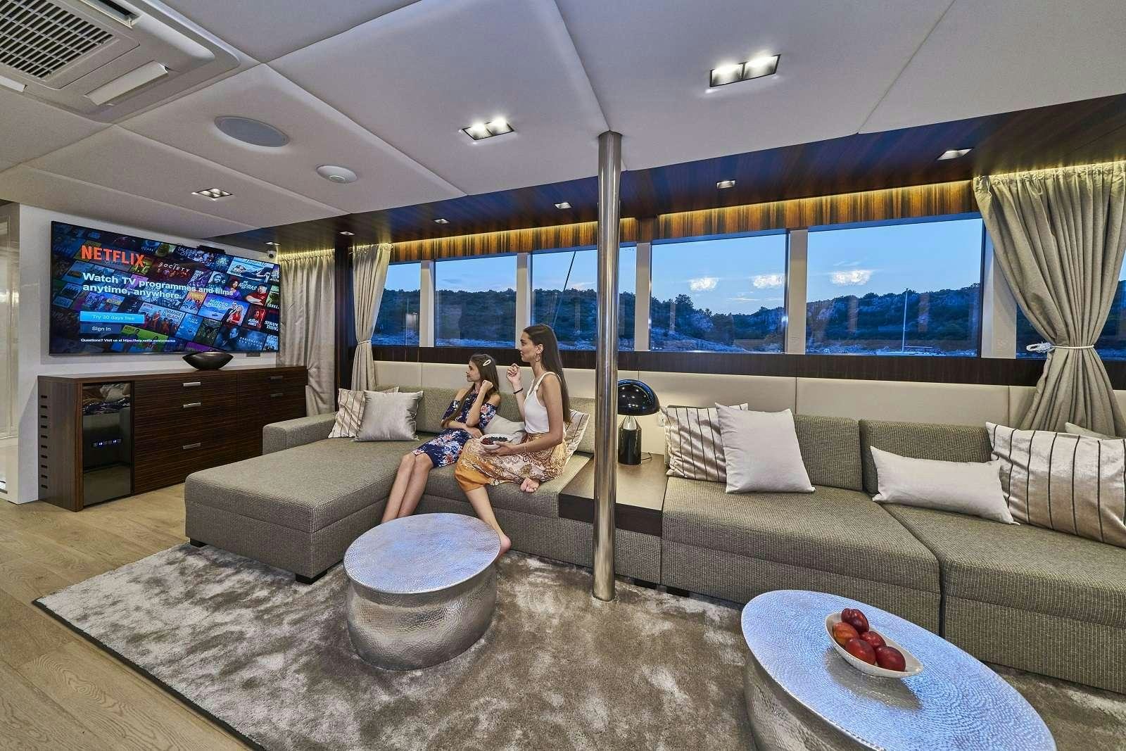 a person sitting on a couch aboard DALMATINO Yacht for Charter