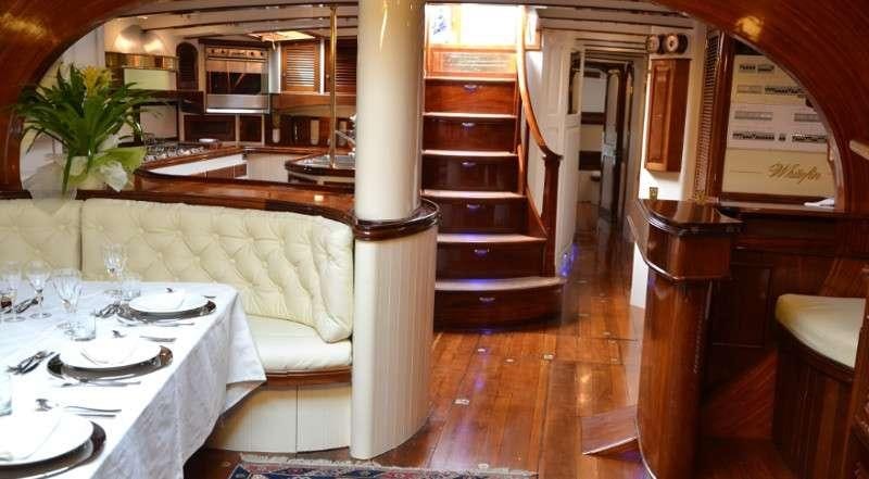 a room with a table and chairs aboard WHITEFIN Yacht for Charter