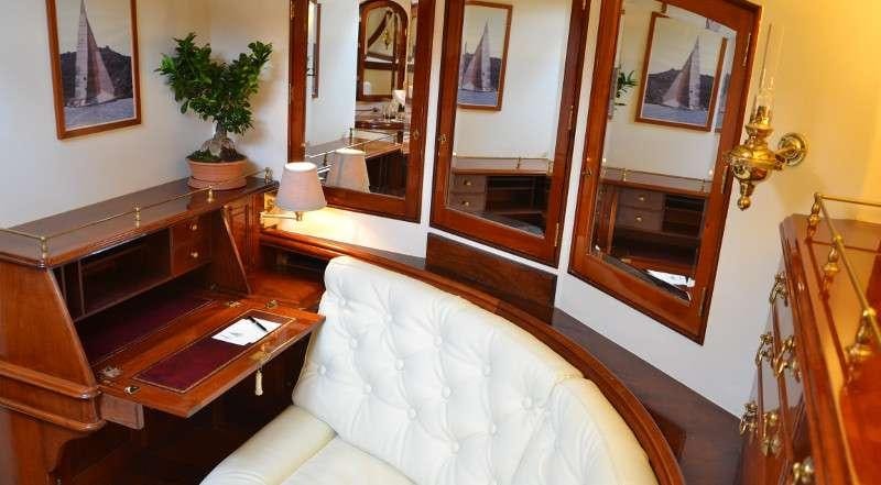a living room with a piano aboard WHITEFIN Yacht for Charter