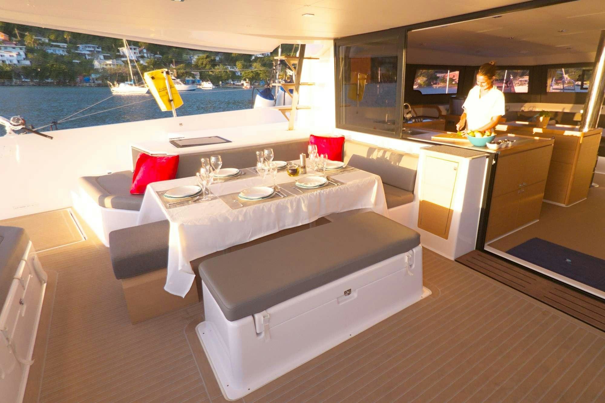 a room with a table and chairs aboard NeuroSeas Yacht for Charter