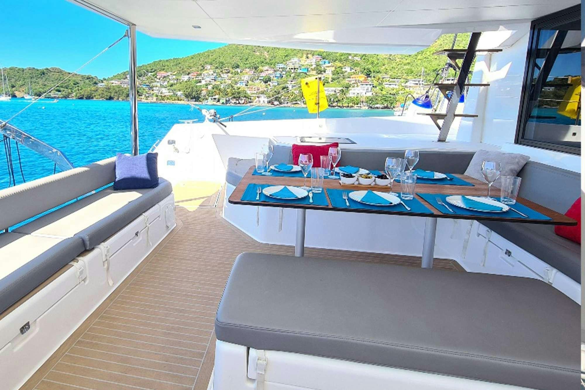 a table on a deck aboard NeuroSeas Yacht for Charter