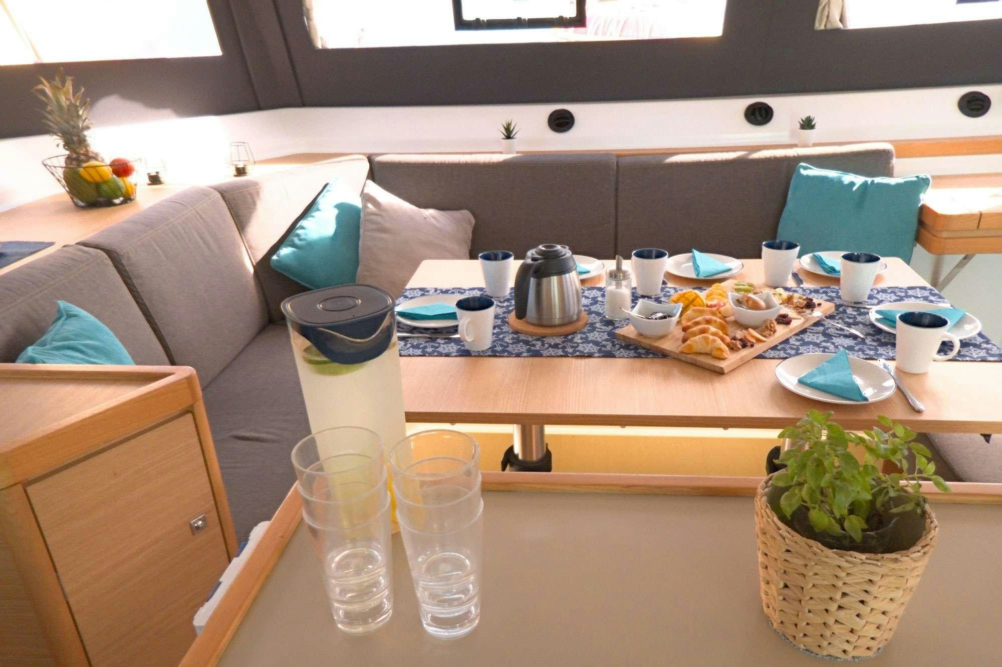 a table with food and drinks on it aboard NeuroSeas Yacht for Charter