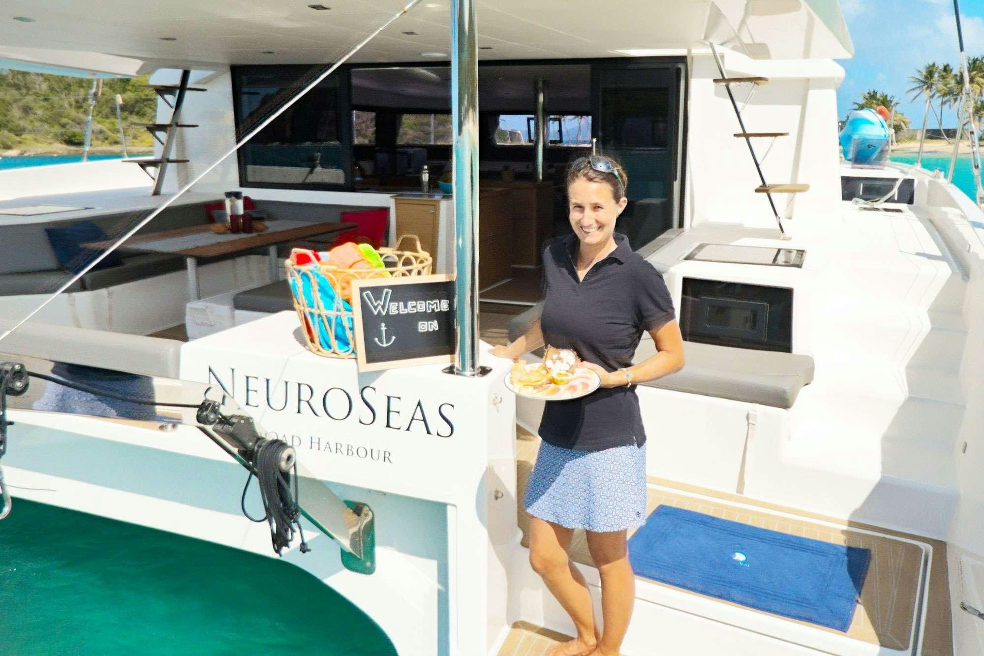 a person holding a plate of food aboard NeuroSeas Yacht for Charter