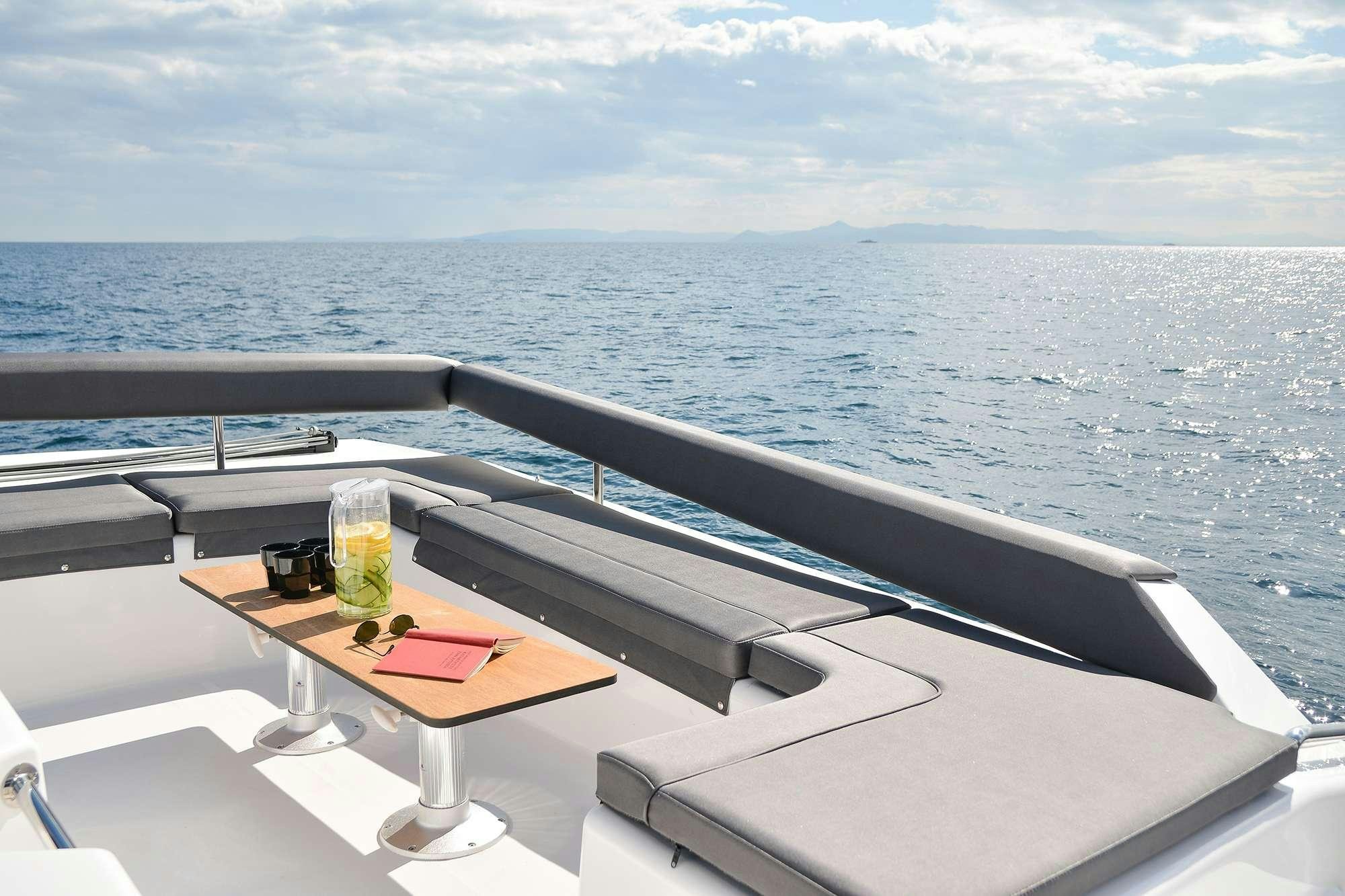 a table with a drink on it aboard NeuroSeas Yacht for Charter