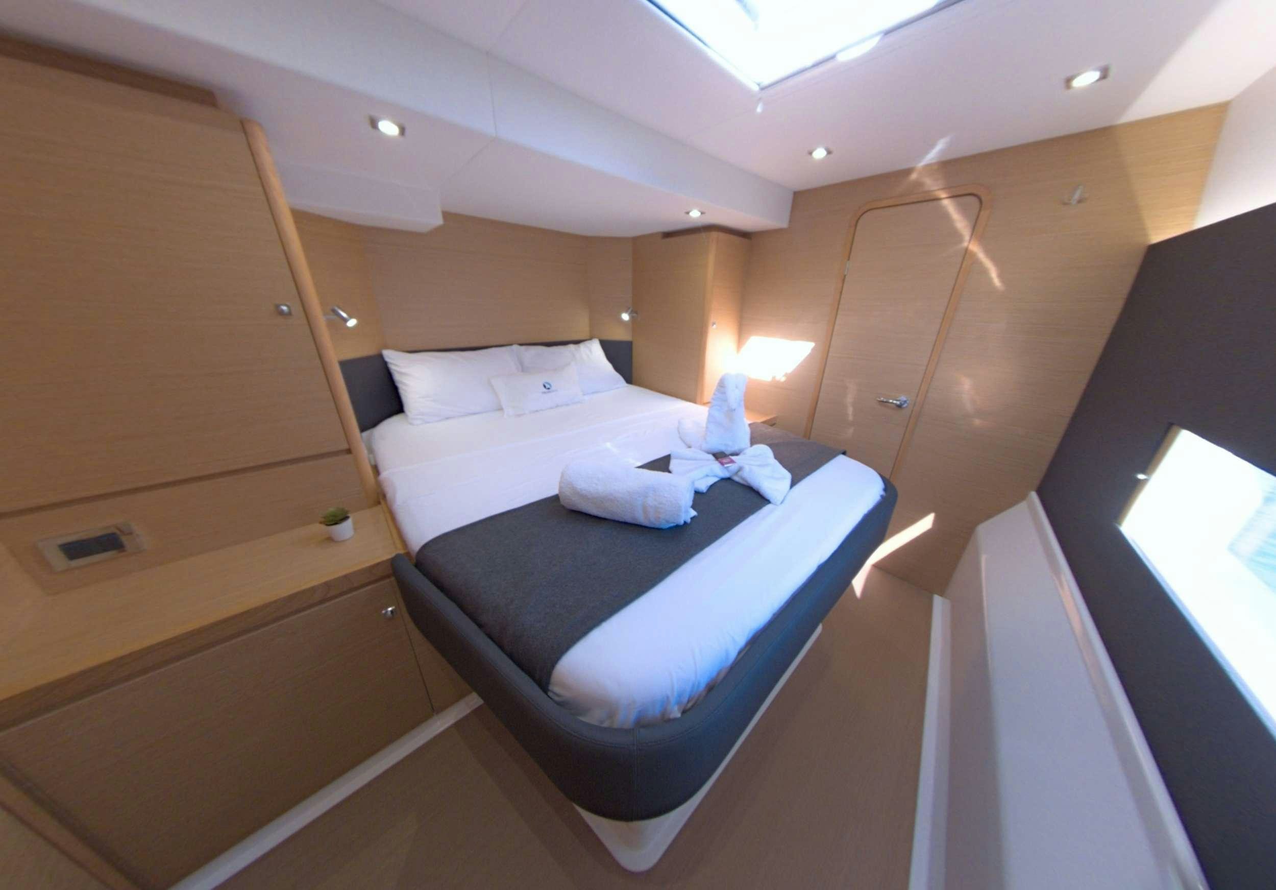 a bed in a room aboard NeuroSeas Yacht for Charter