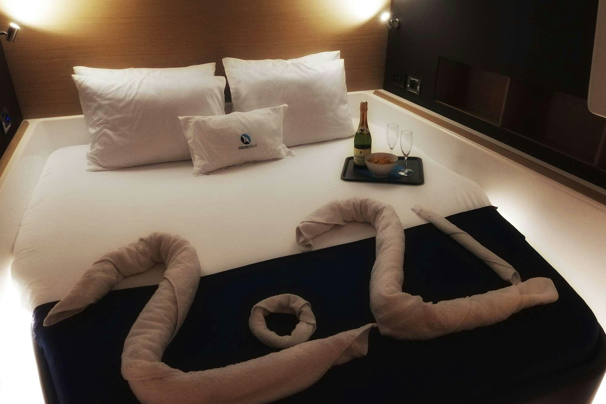 a person lying on a bed aboard NeuroSeas Yacht for Charter