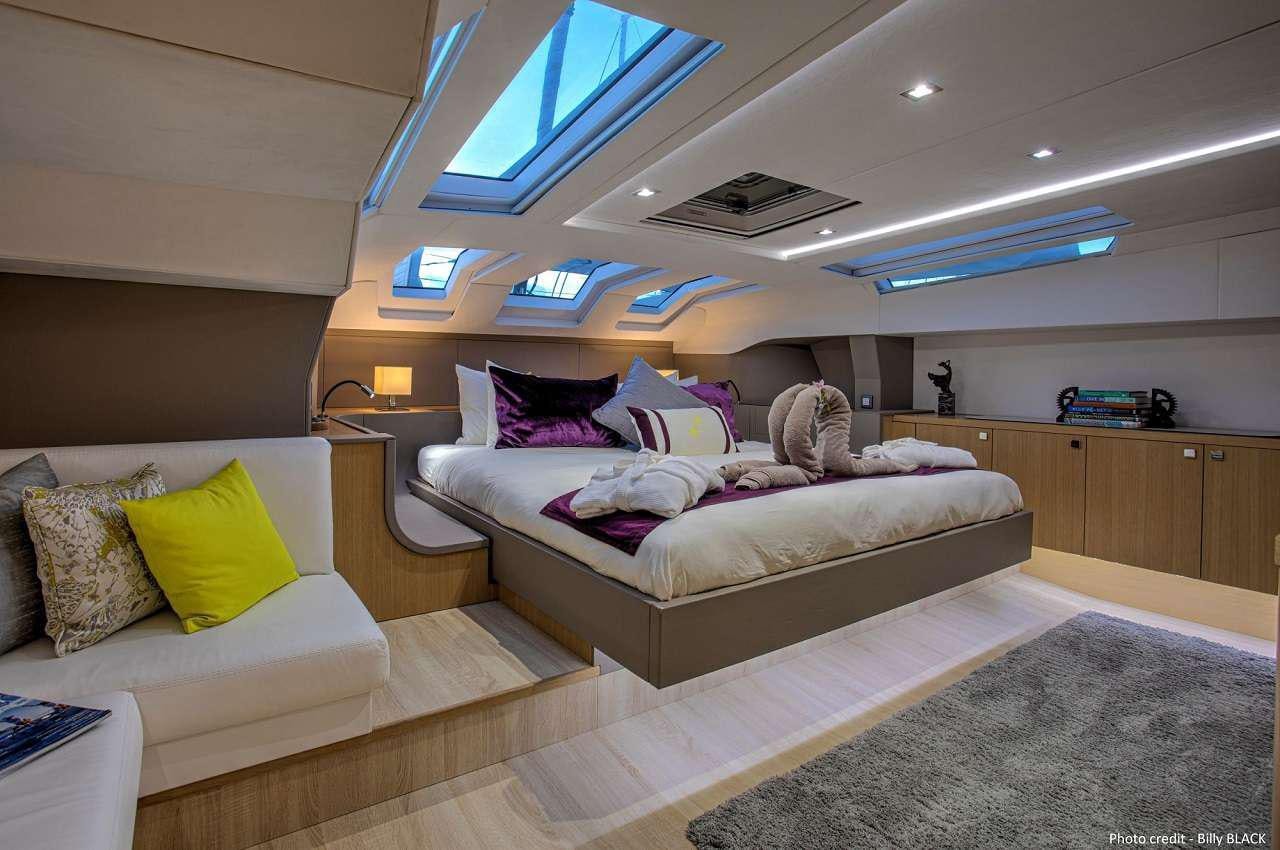 a person lying on a bed aboard NAMASTE Yacht for Charter