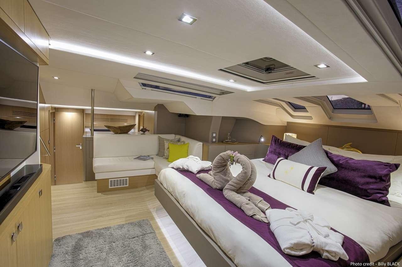 a bedroom with a bed and a desk aboard NAMASTE Yacht for Charter