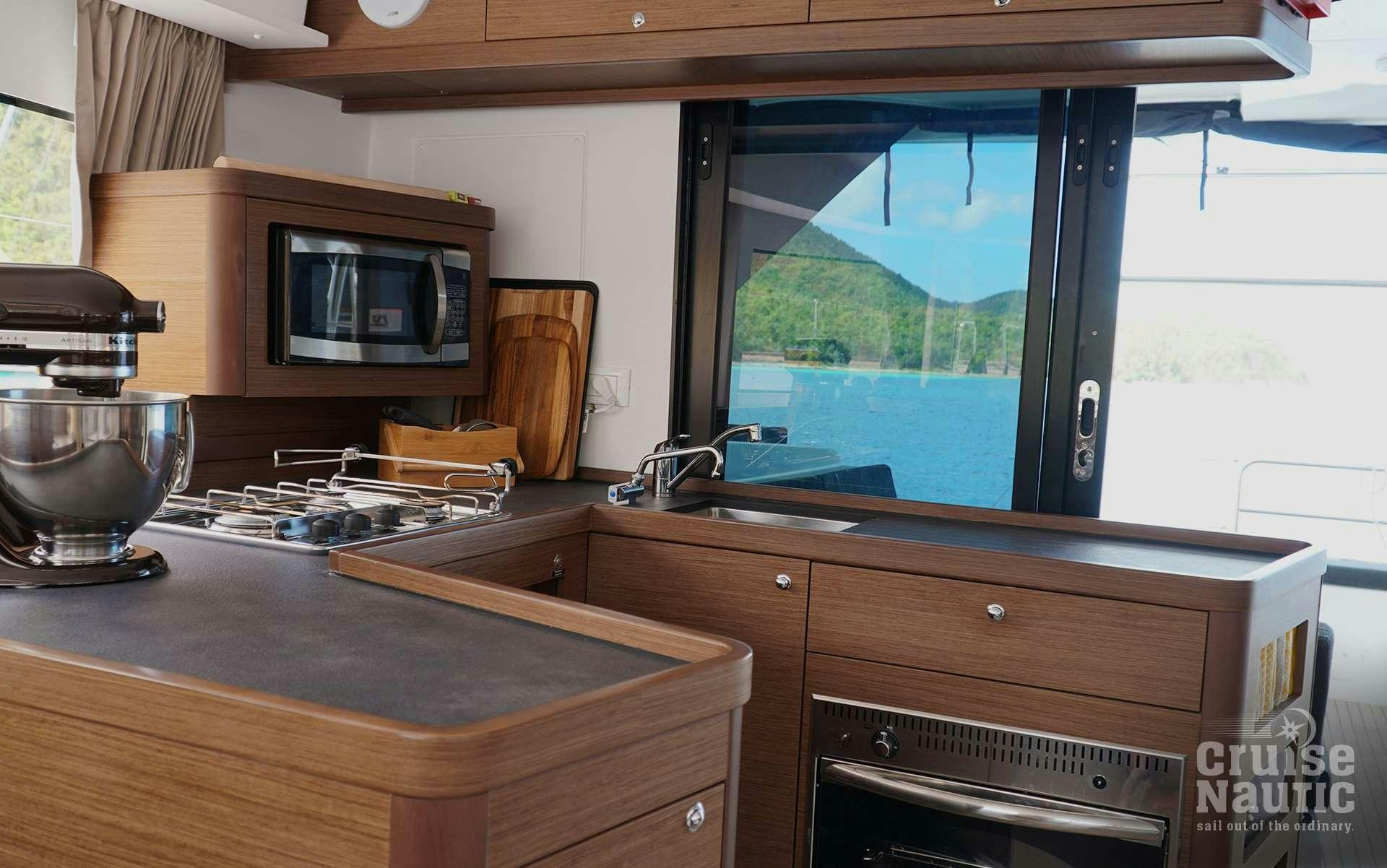 a kitchen with a large window aboard CruiseNautic Yacht for Charter