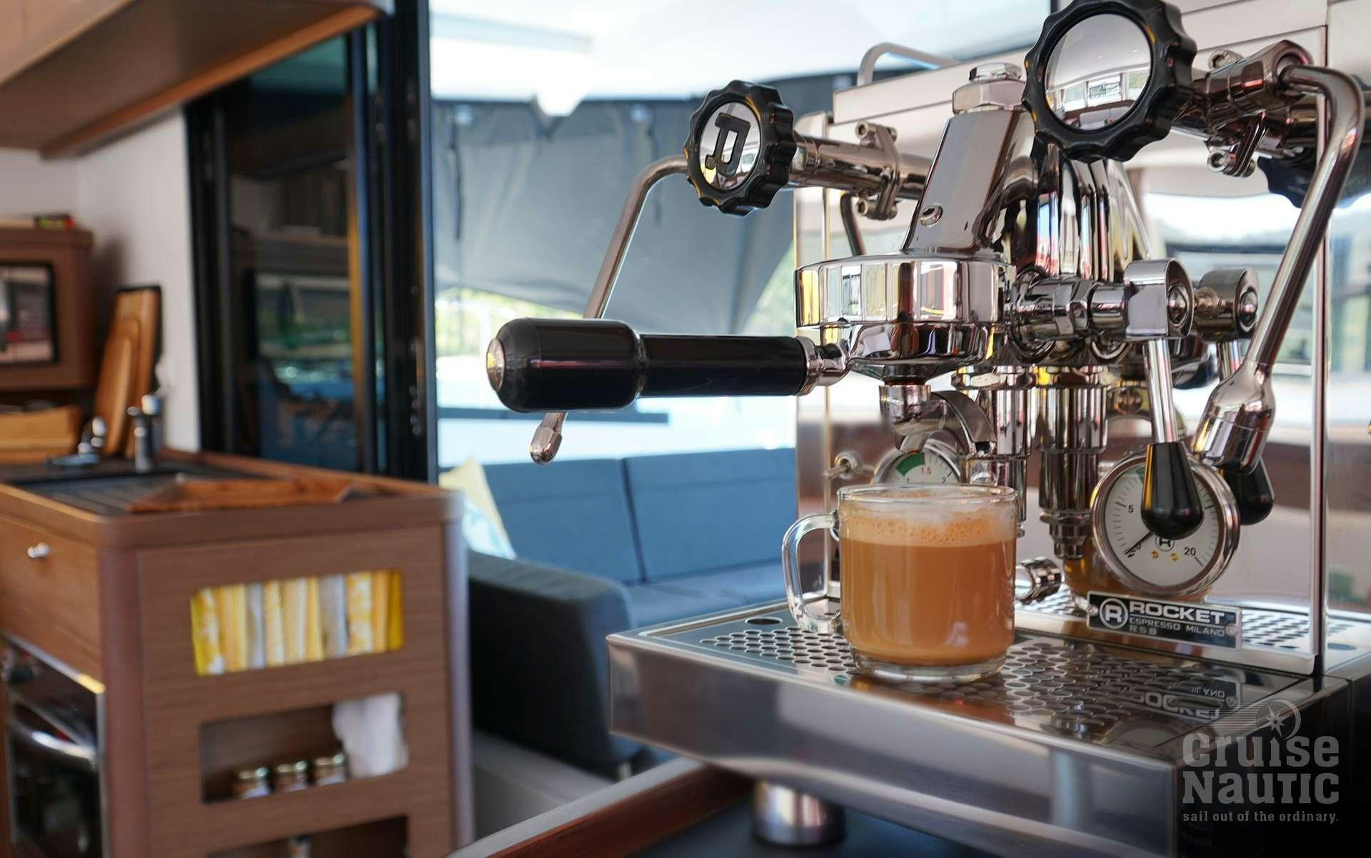 a machine with a glass of liquid aboard CruiseNautic Yacht for Charter