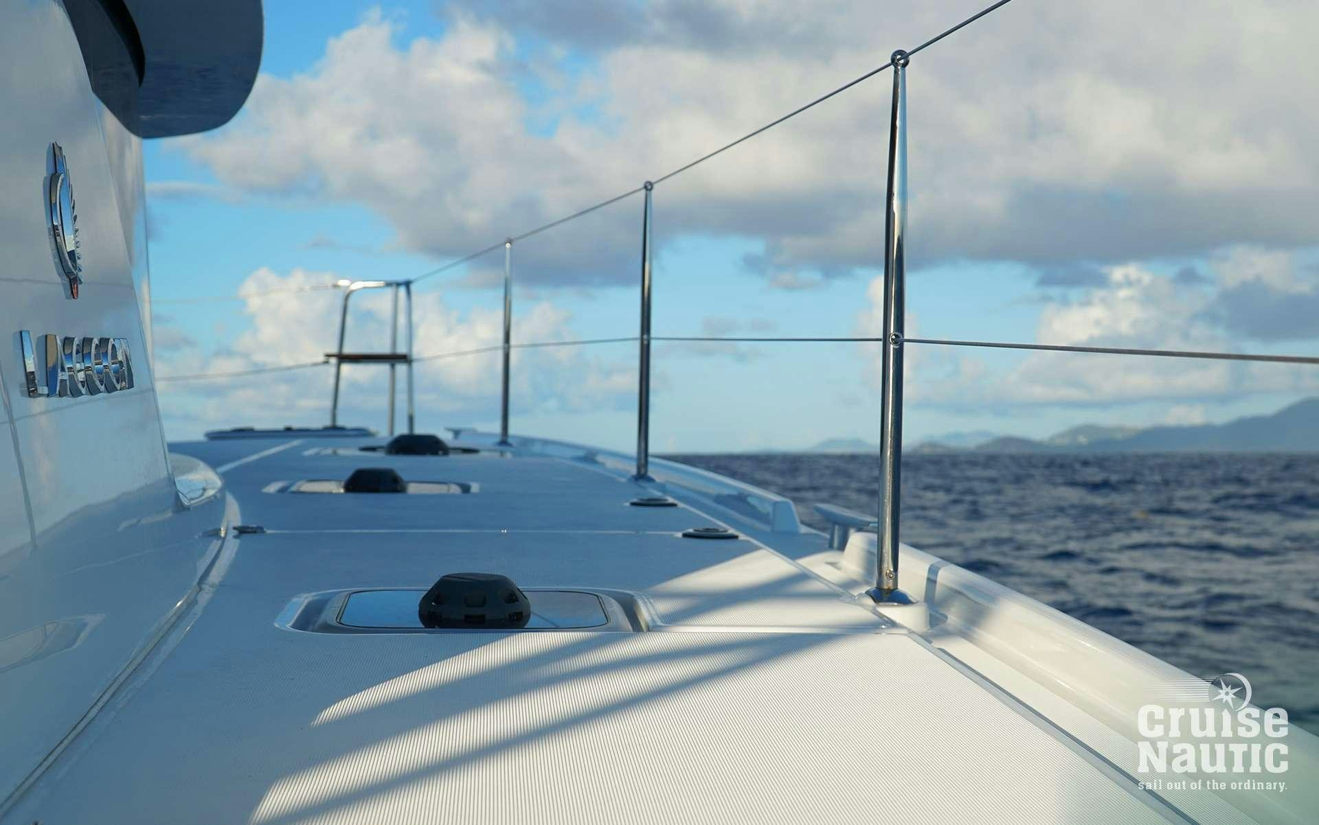 a view of a boat on the water with a large ship in the background aboard CruiseNautic Yacht for Charter