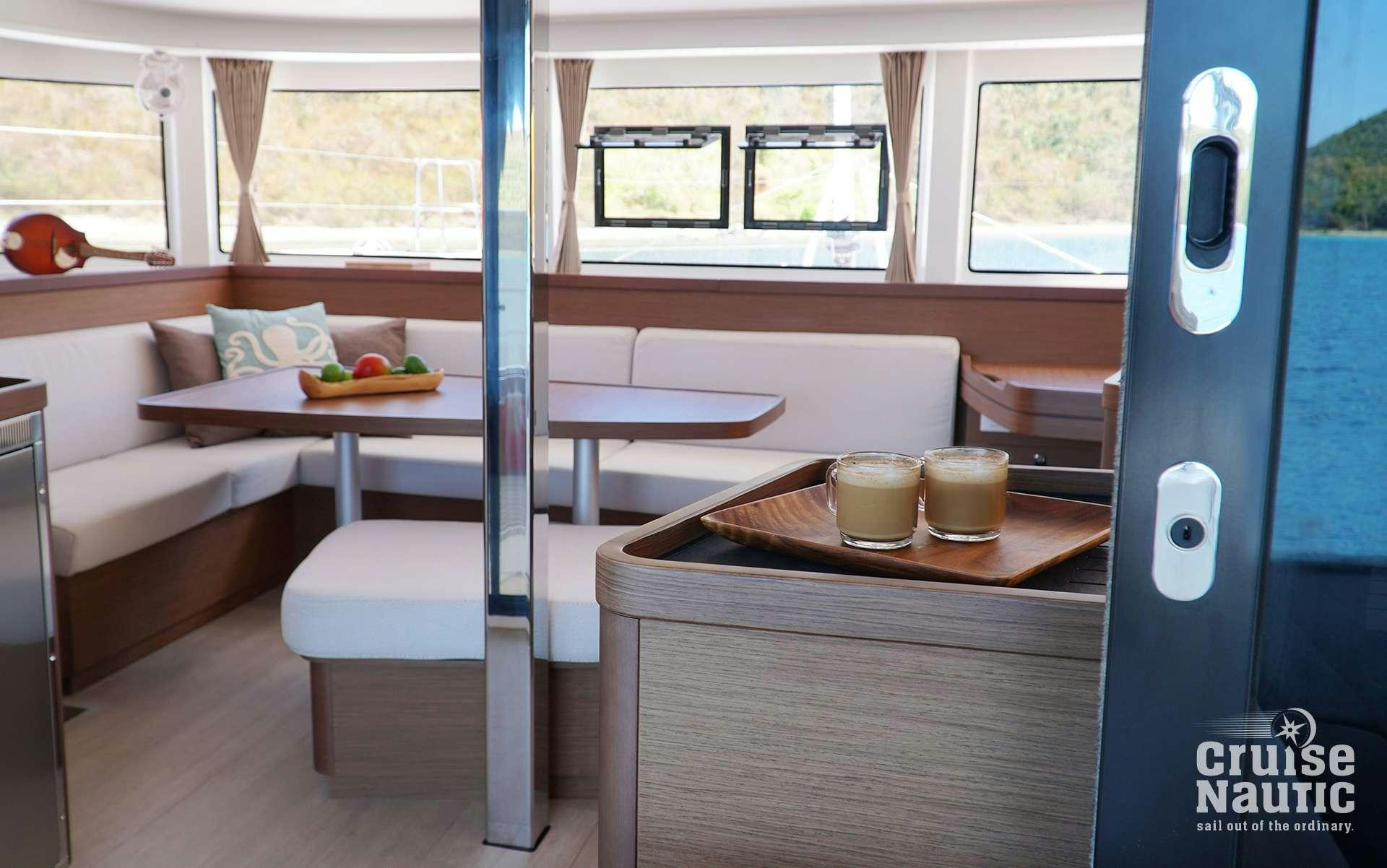a room with a bed and a table aboard CruiseNautic Yacht for Charter