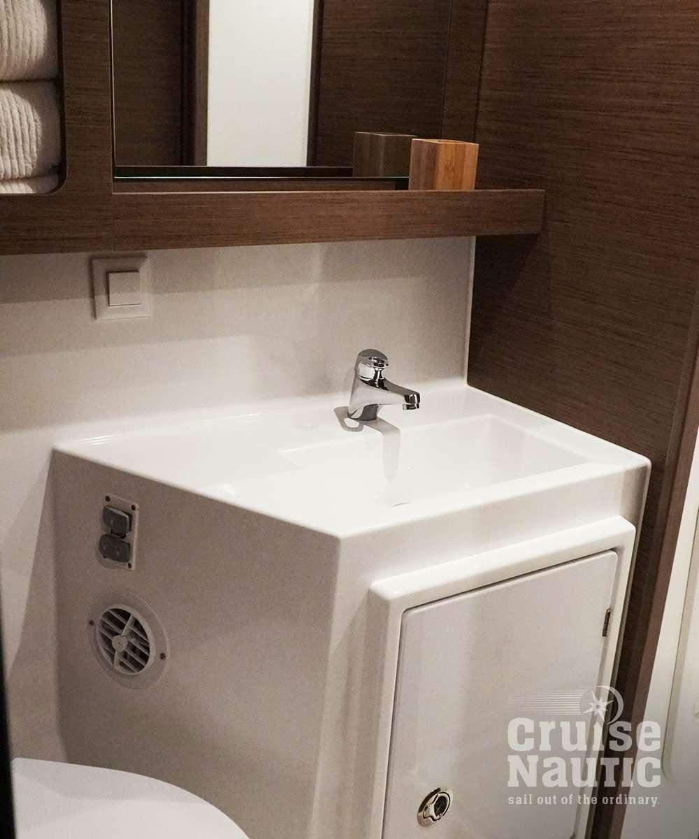 a bathroom sink with a mirror above it aboard CruiseNautic Yacht for Charter