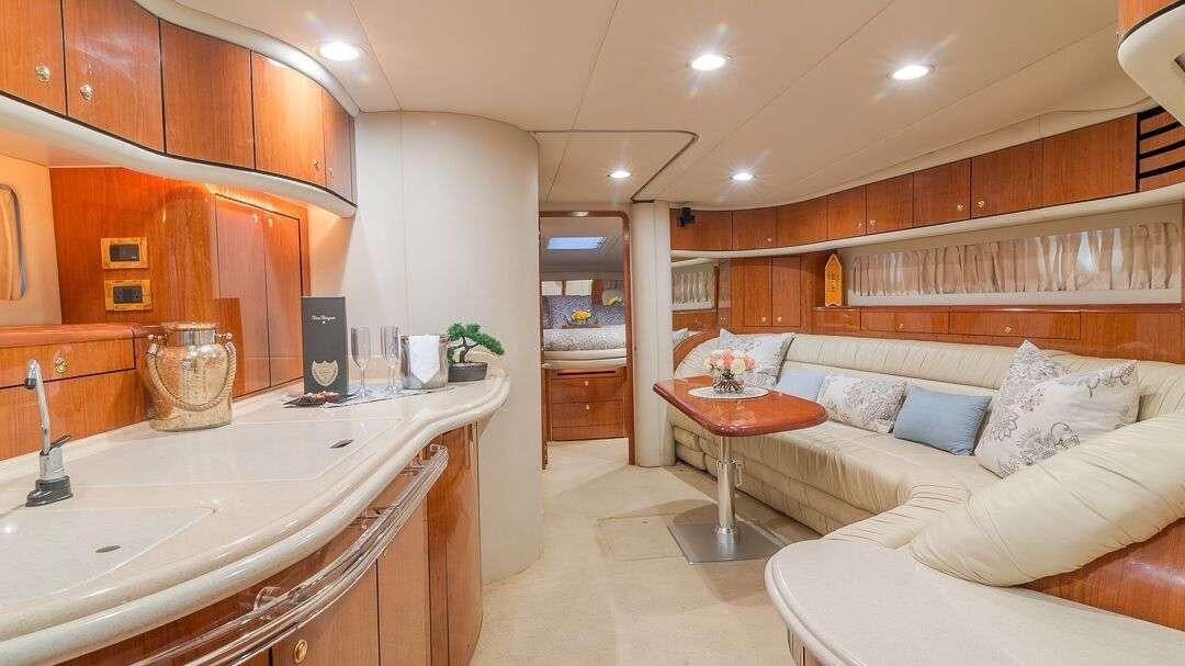 a large room with a bed and a couch aboard WHY NOT Yacht for Charter