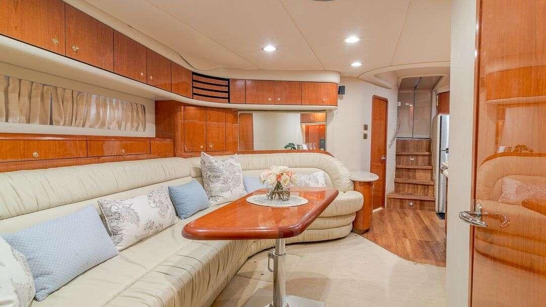 a living room with a couch and a table aboard WHY NOT Yacht for Charter