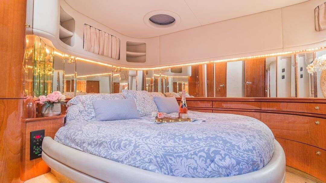 a bed with a blue sheet aboard WHY NOT Yacht for Charter