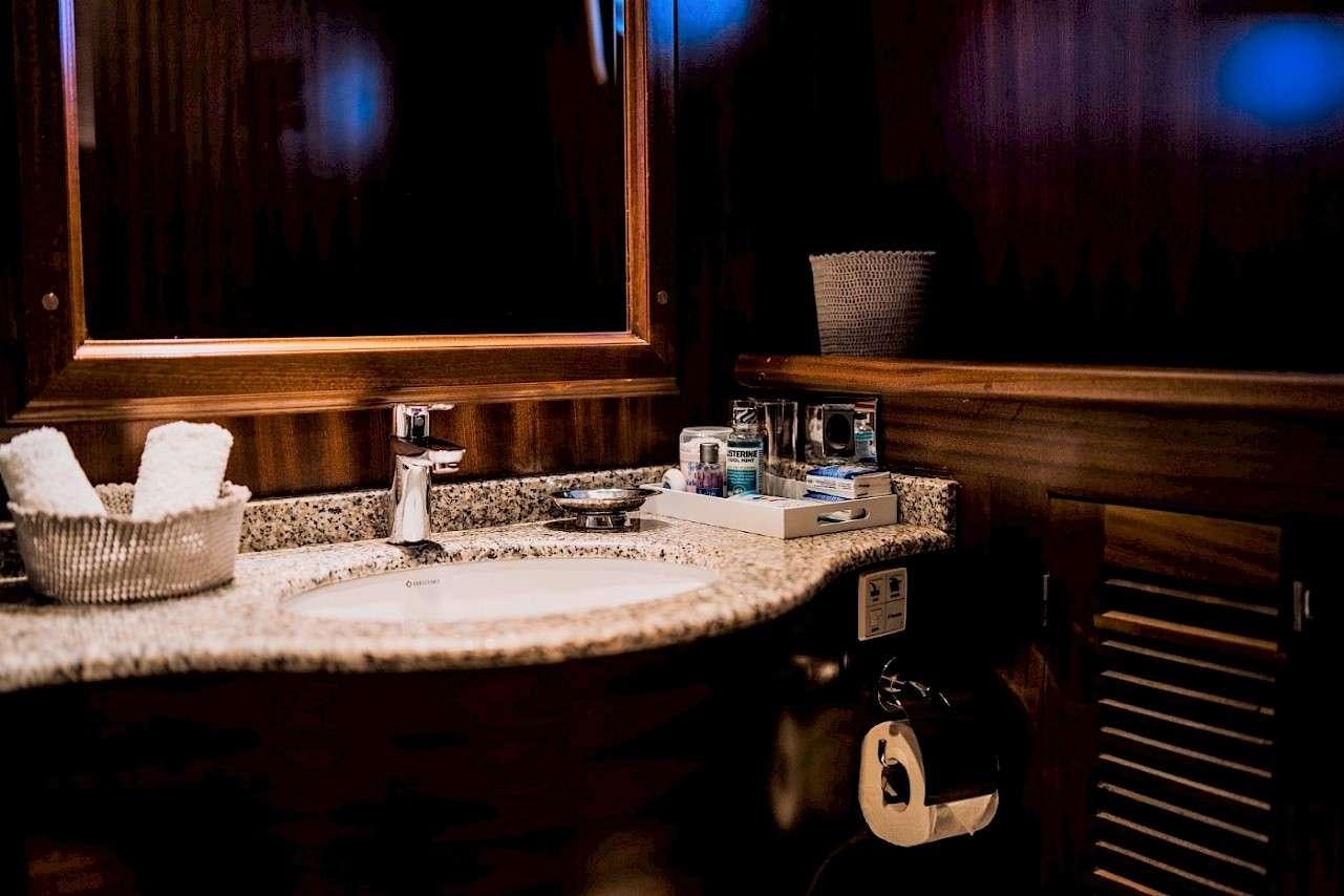 a bathroom with a sink and mirror aboard CAPRICORN 1 Yacht for Charter