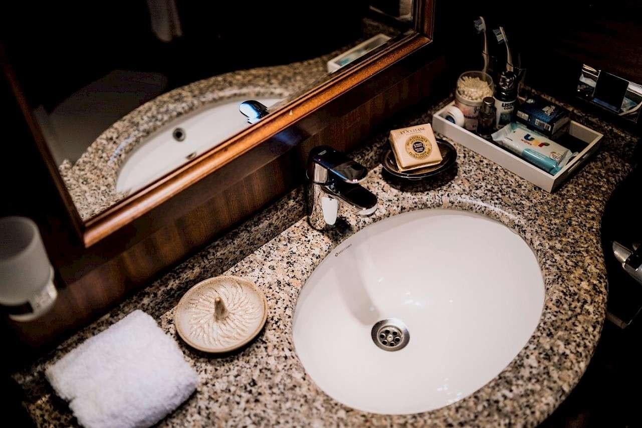 a bathroom with a sink and a mirror aboard CAPRICORN 1 Yacht for Charter
