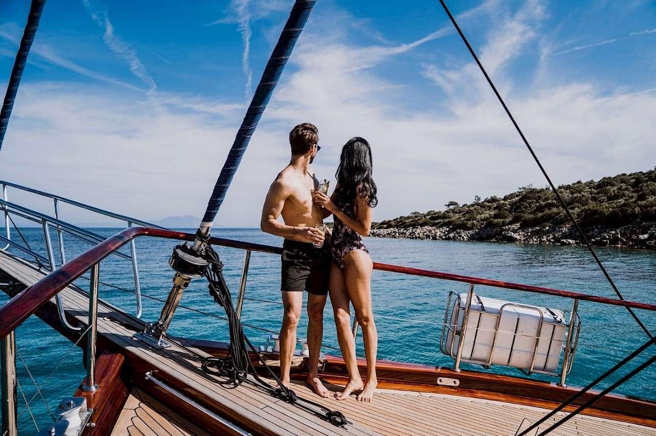 a man and woman on a boat aboard CAPRICORN 1 Yacht for Charter