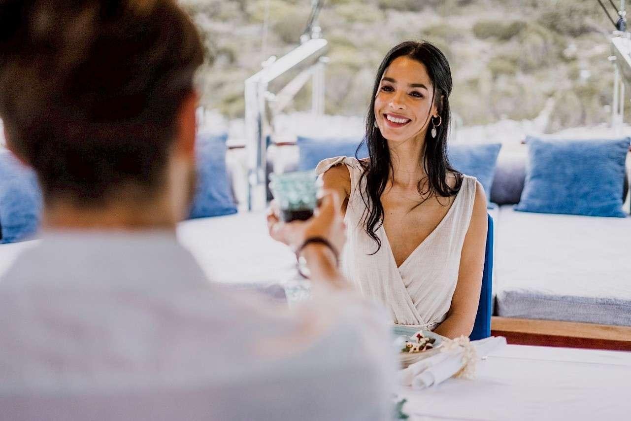a woman holding a glass of wine aboard CAPRICORN 1 Yacht for Charter
