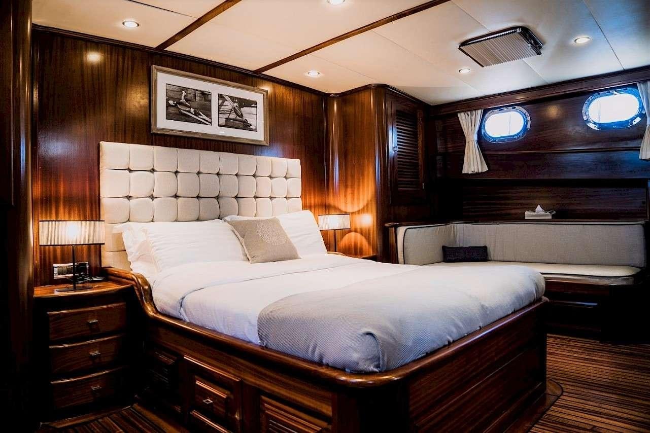 a large bed in a room aboard CAPRICORN 1 Yacht for Charter