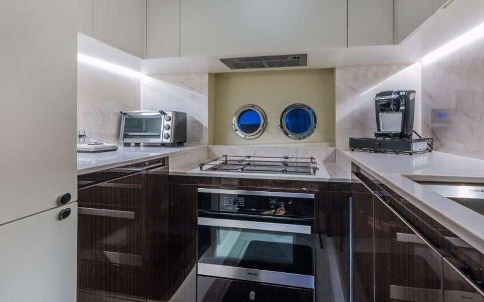 a kitchen with a stove and oven aboard CARPE DIEM Yacht for Charter
