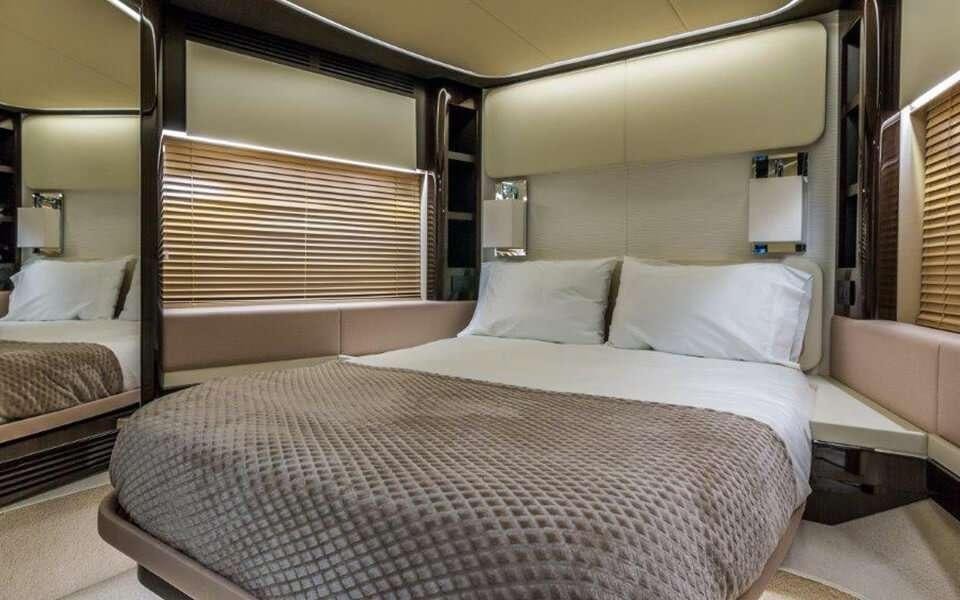 a room with a bed and a window aboard CARPE DIEM Yacht for Charter